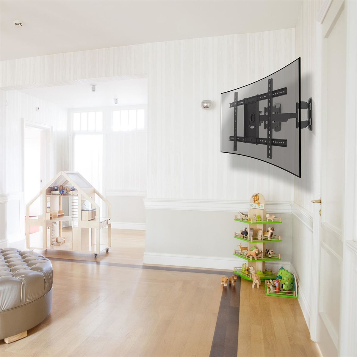 A modern living room with a TV mounted on the wall. There is a dollhouse and a wooden toy stand.
