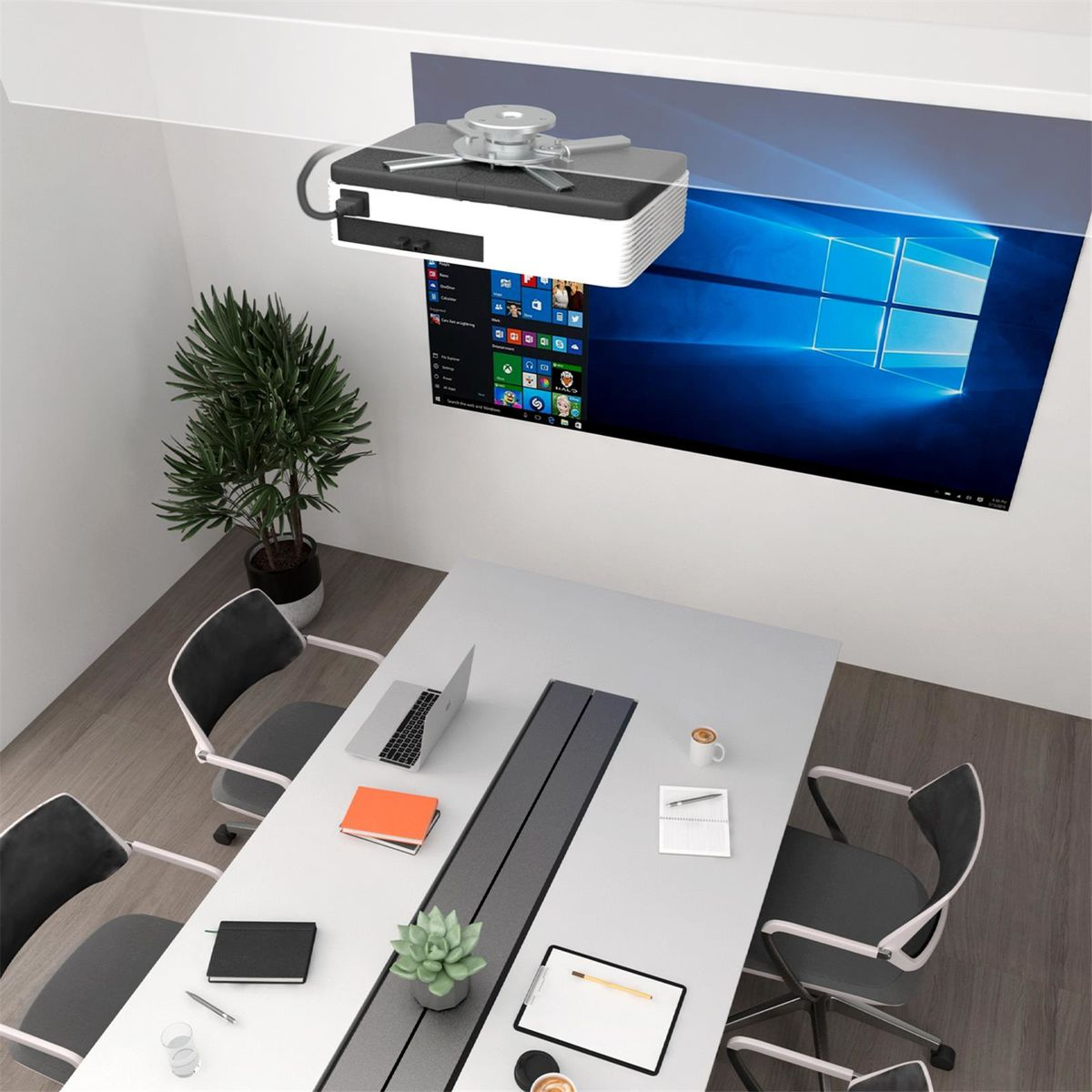 A projector is mounted on the ceiling, projecting an image onto the wall above a conference table.