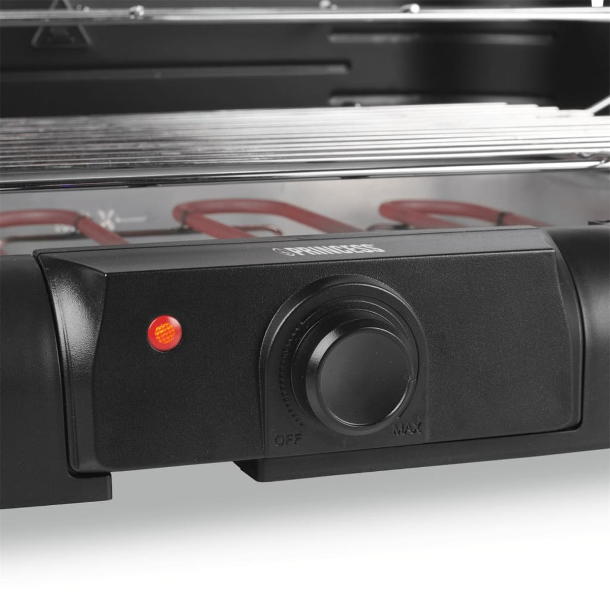 Close-up of a black grill control panel with an 'OFF-MAX' dial and red light.