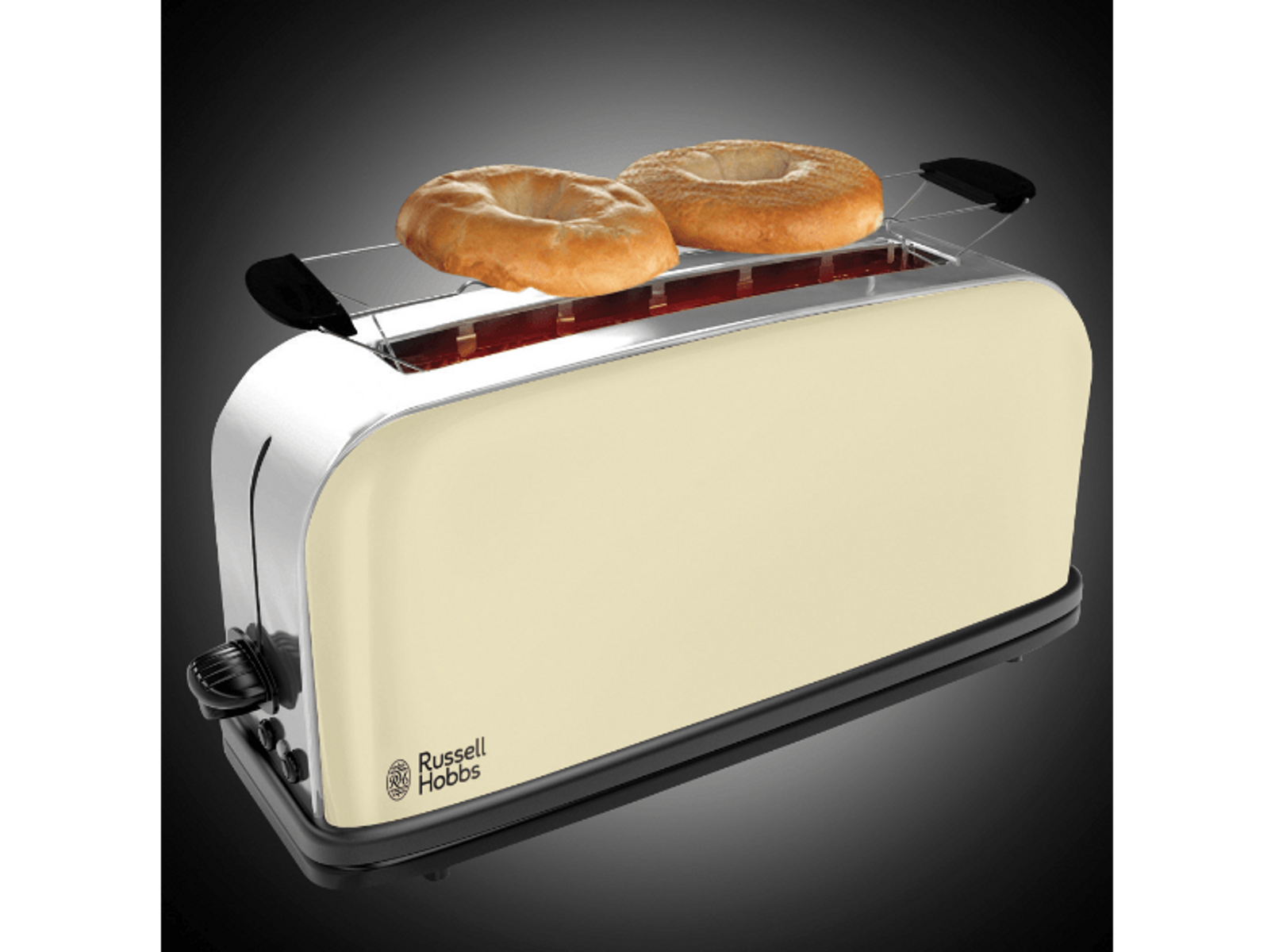 Kremowy toster z dwoma bajglami. Toster stoi na czarnej powierzchni.