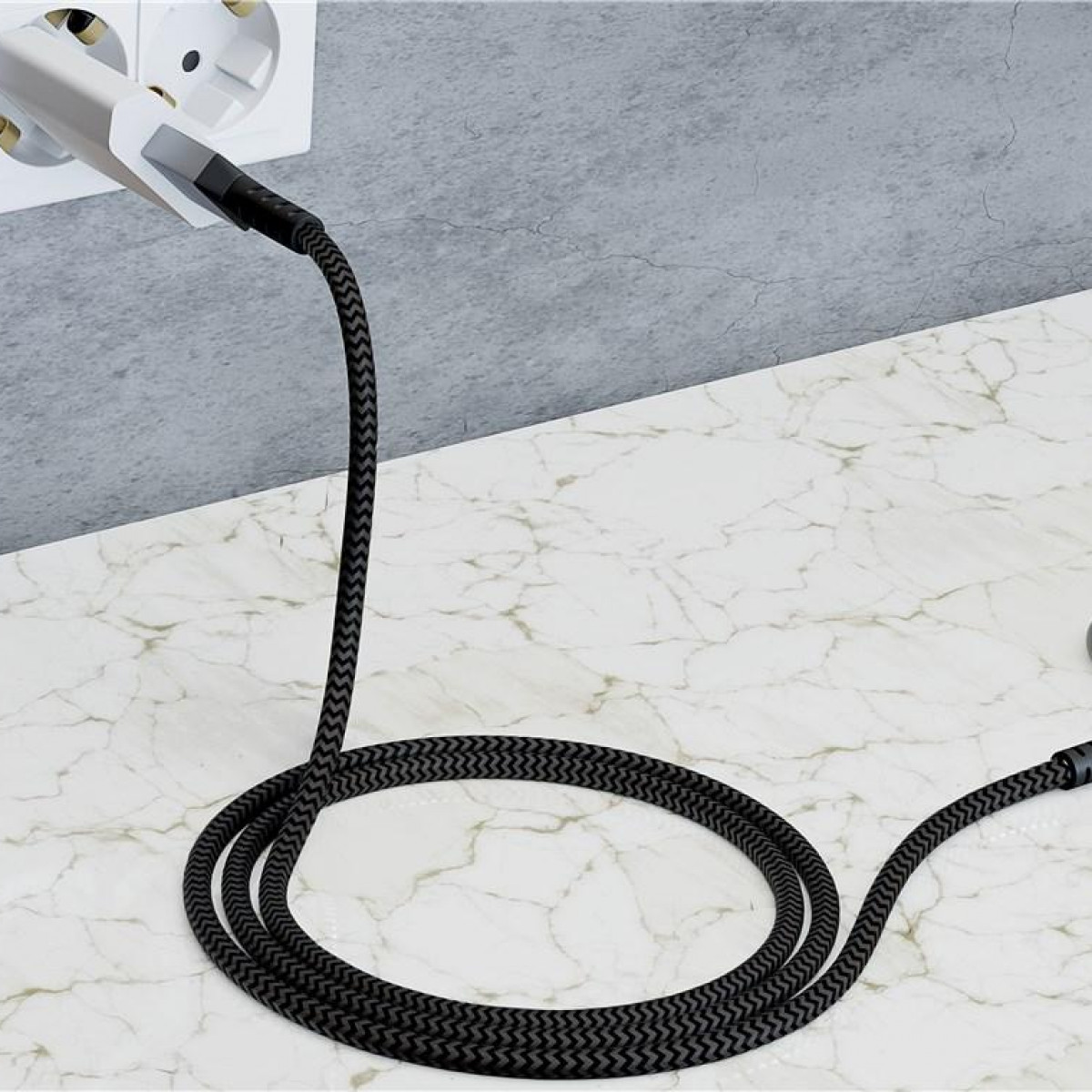 Black braided cable plugged into a wall outlet on a marble surface. White background.