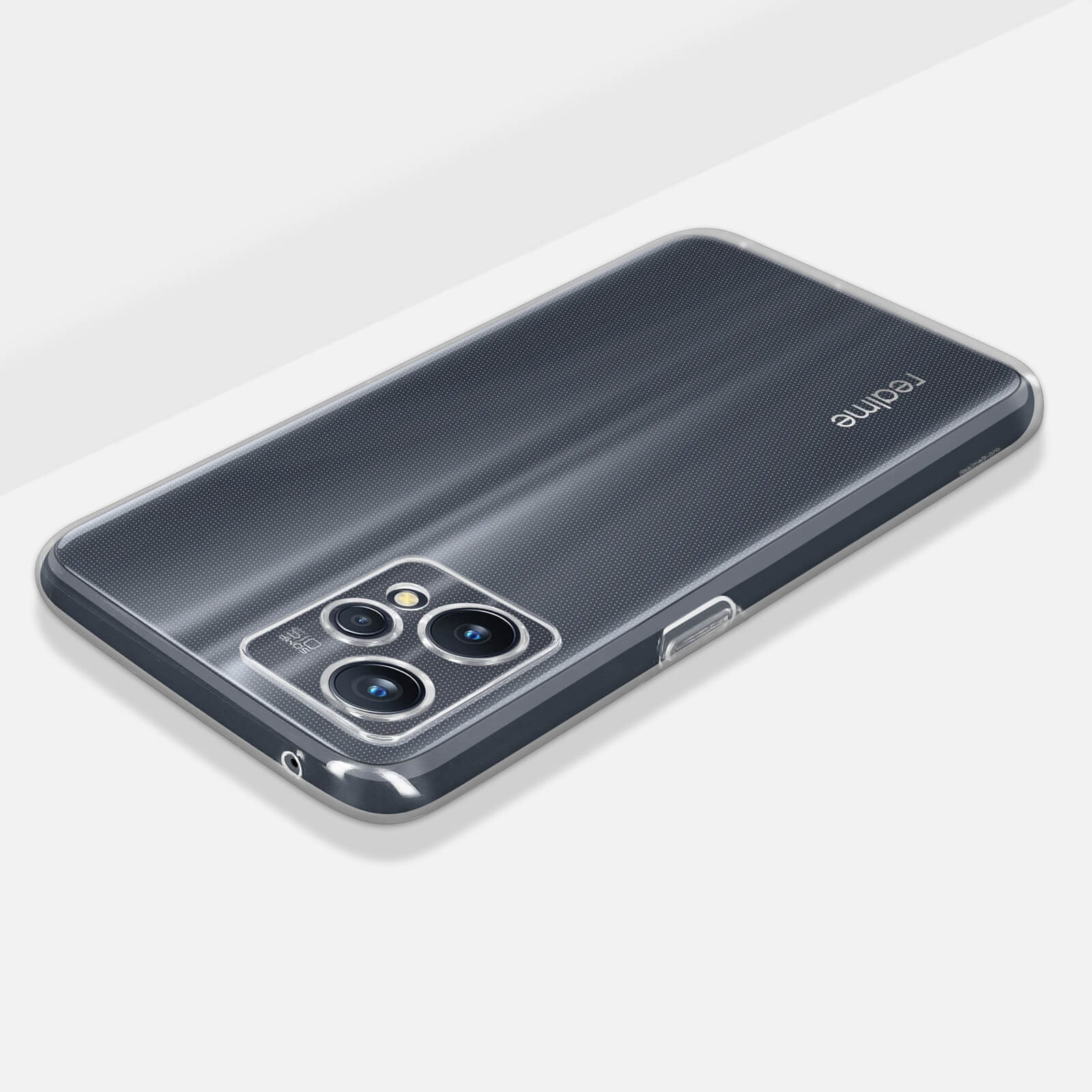 Custodia trasparente per telefono su superficie bianca. Mostra un Realme e una fotocamera.