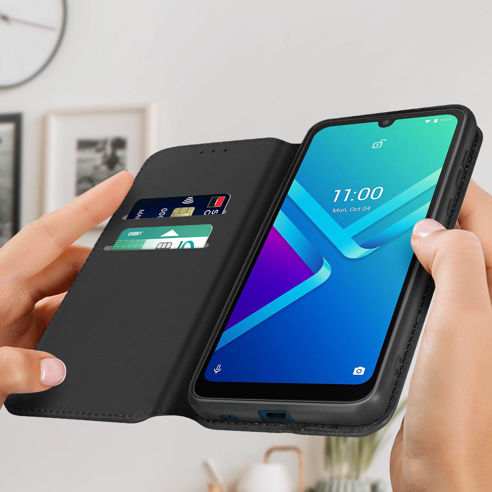 Mani che tengono un telefono in una custodia nera, che mostra uno schermo con app.