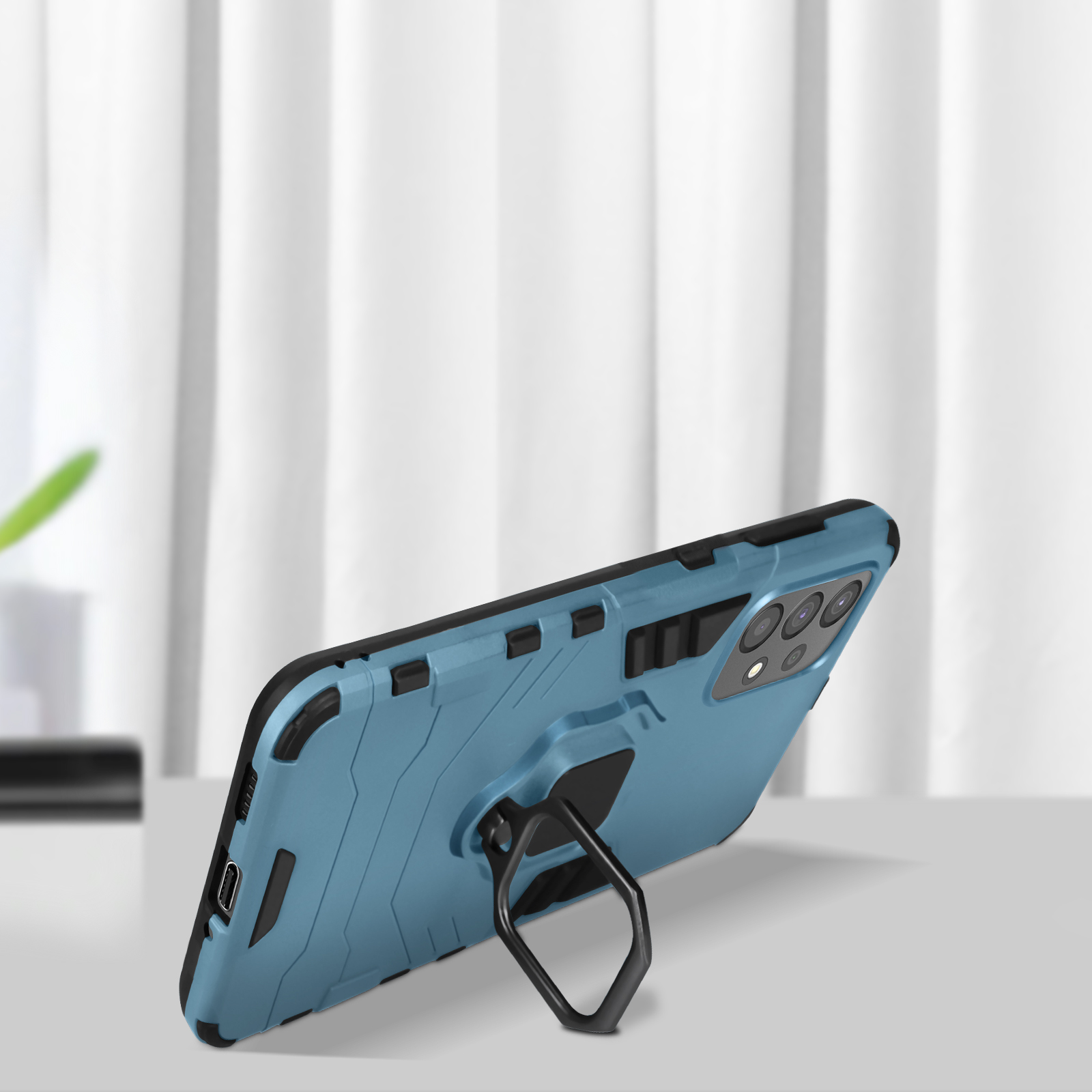 Custodia blu per telefono con supporto ad anello, su superficie bianca.