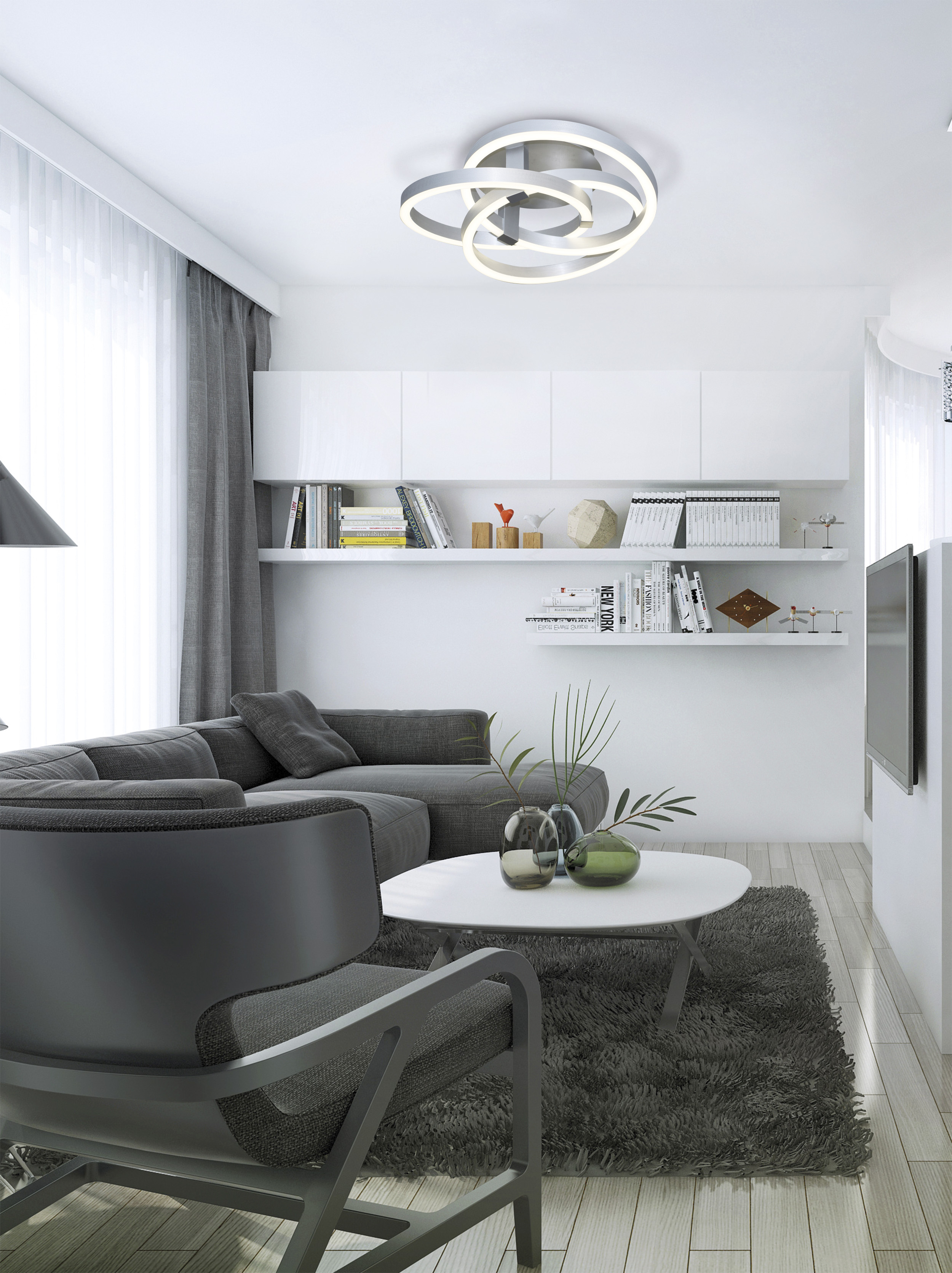 Wohnzimmer mit grauem Sofa, Sessel, weißem Tisch und moderner Deckenleuchte.