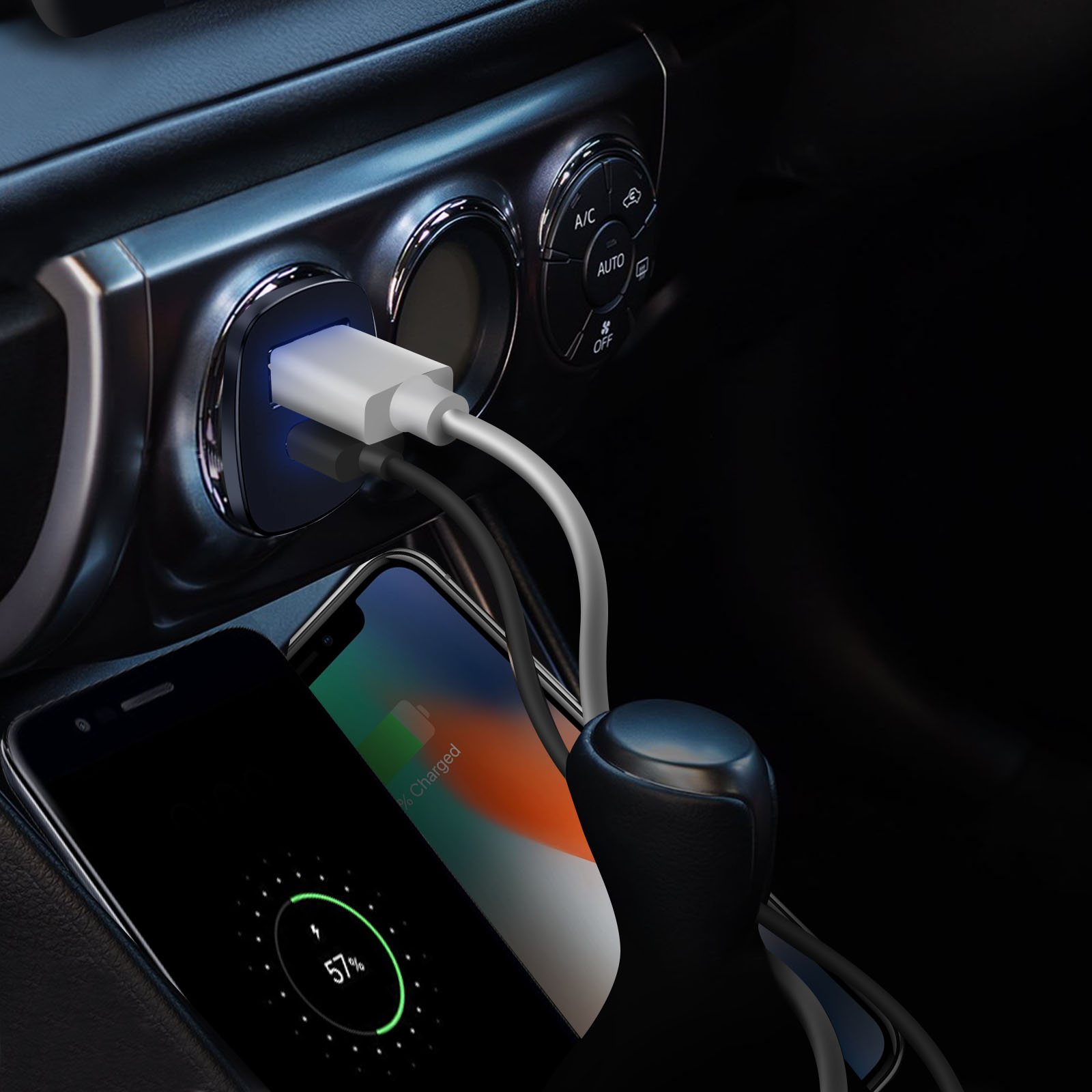 Dwa telefony ładujące się w samochodzie. Jeden jest czarny, drugi pomarańczowy, a ładowarka jest podłączona.