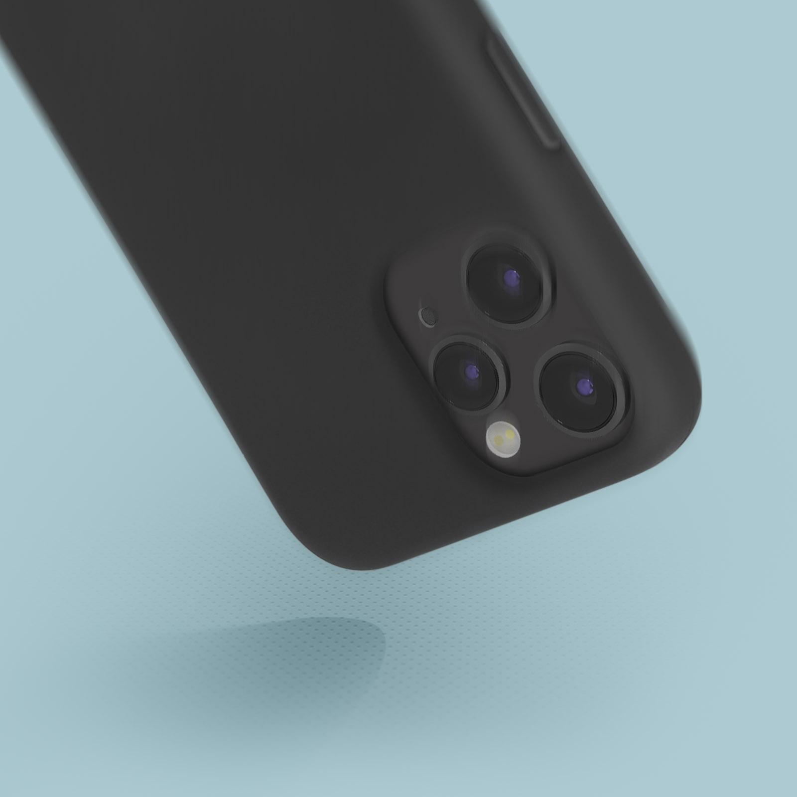 Téléphone noir avec trois caméras arrière, sur une surface bleu clair.