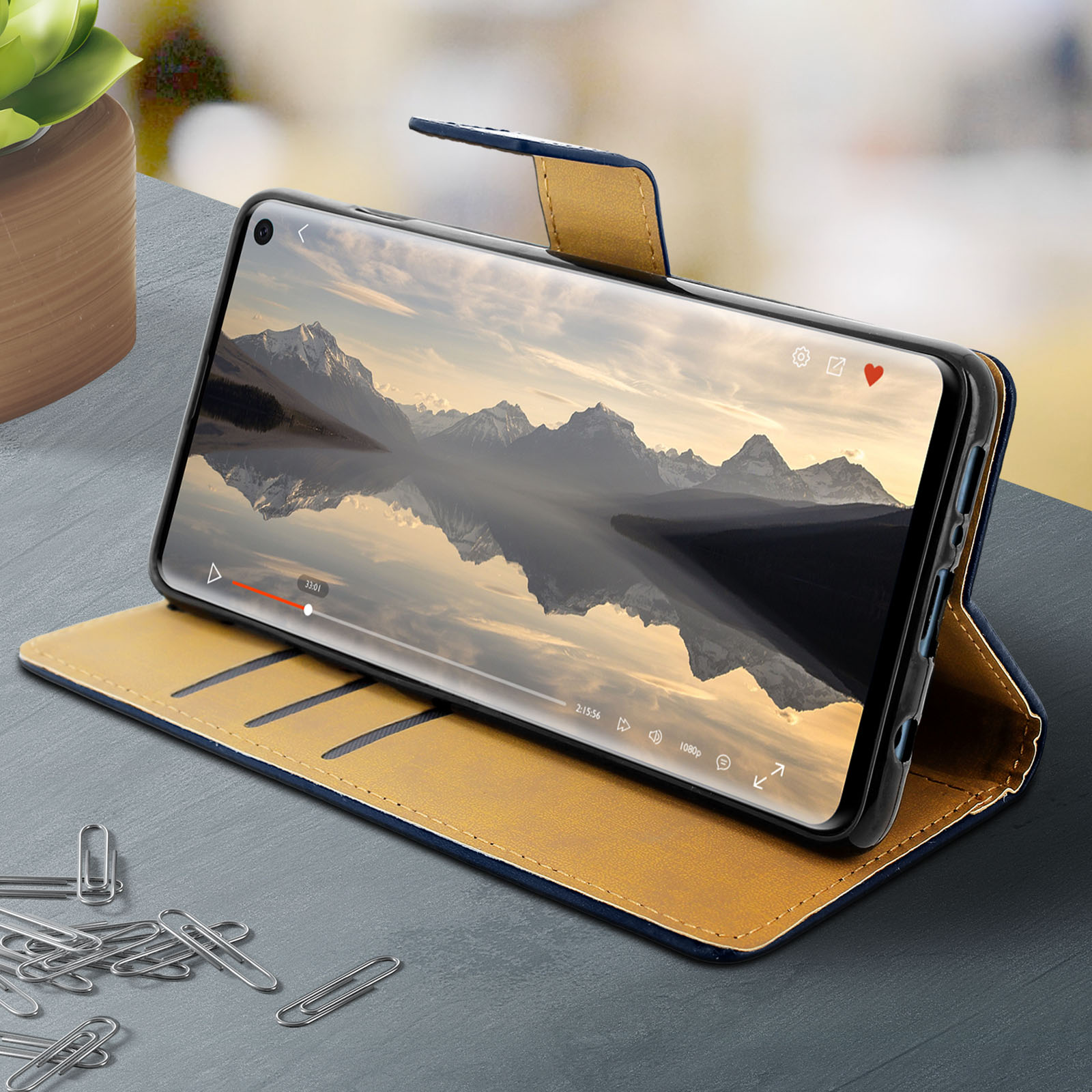 Tablet in custodia blu e gialla, mostra un video di montagne e lago.