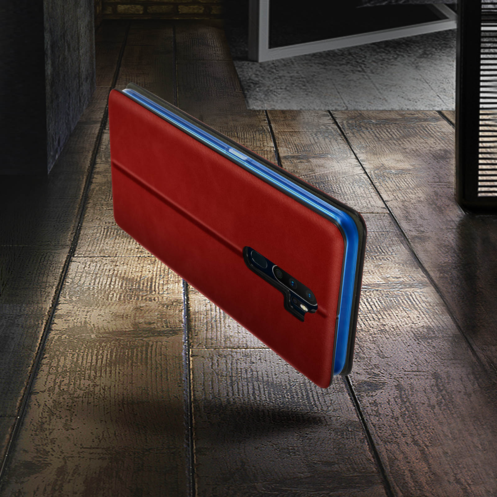 Custodia rossa per telefono su una superficie di legno. Il telefono è blu. La custodia è aperta.