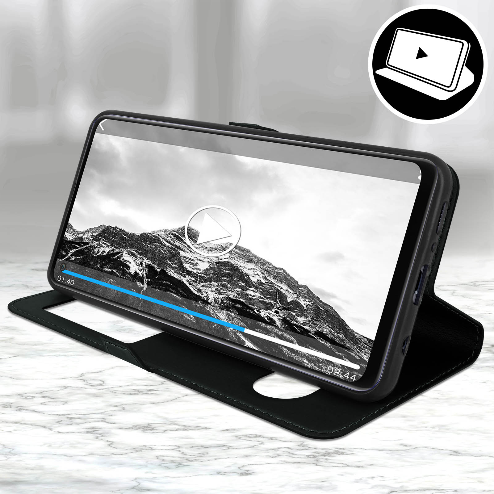 Coque de téléphone noire avec écran montrant une vidéo de montagne, sur une surface en marbre. Bouton de lecture visible.