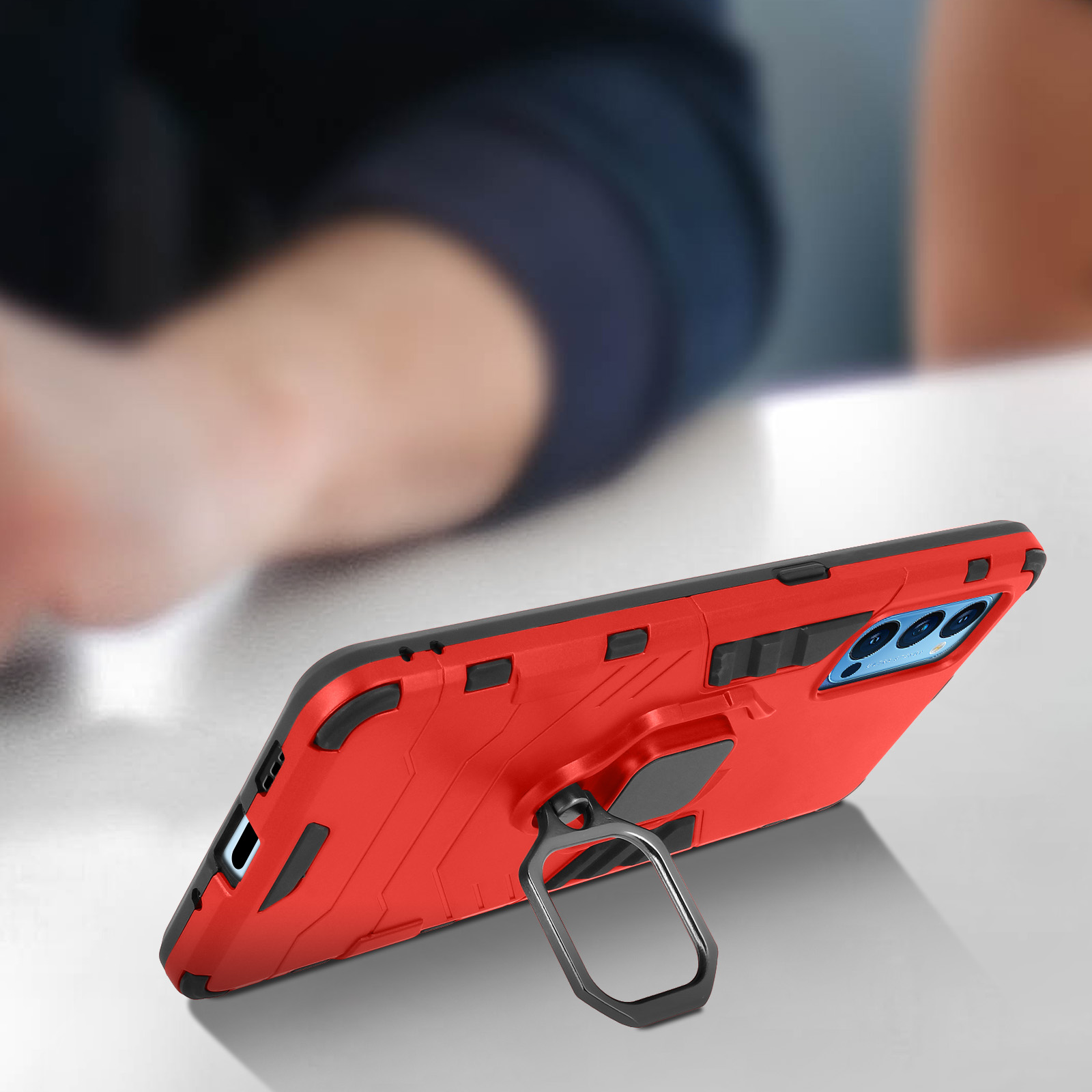 Custodia per telefono rossa con supporto ad anello. Il telefono è su un tavolo.