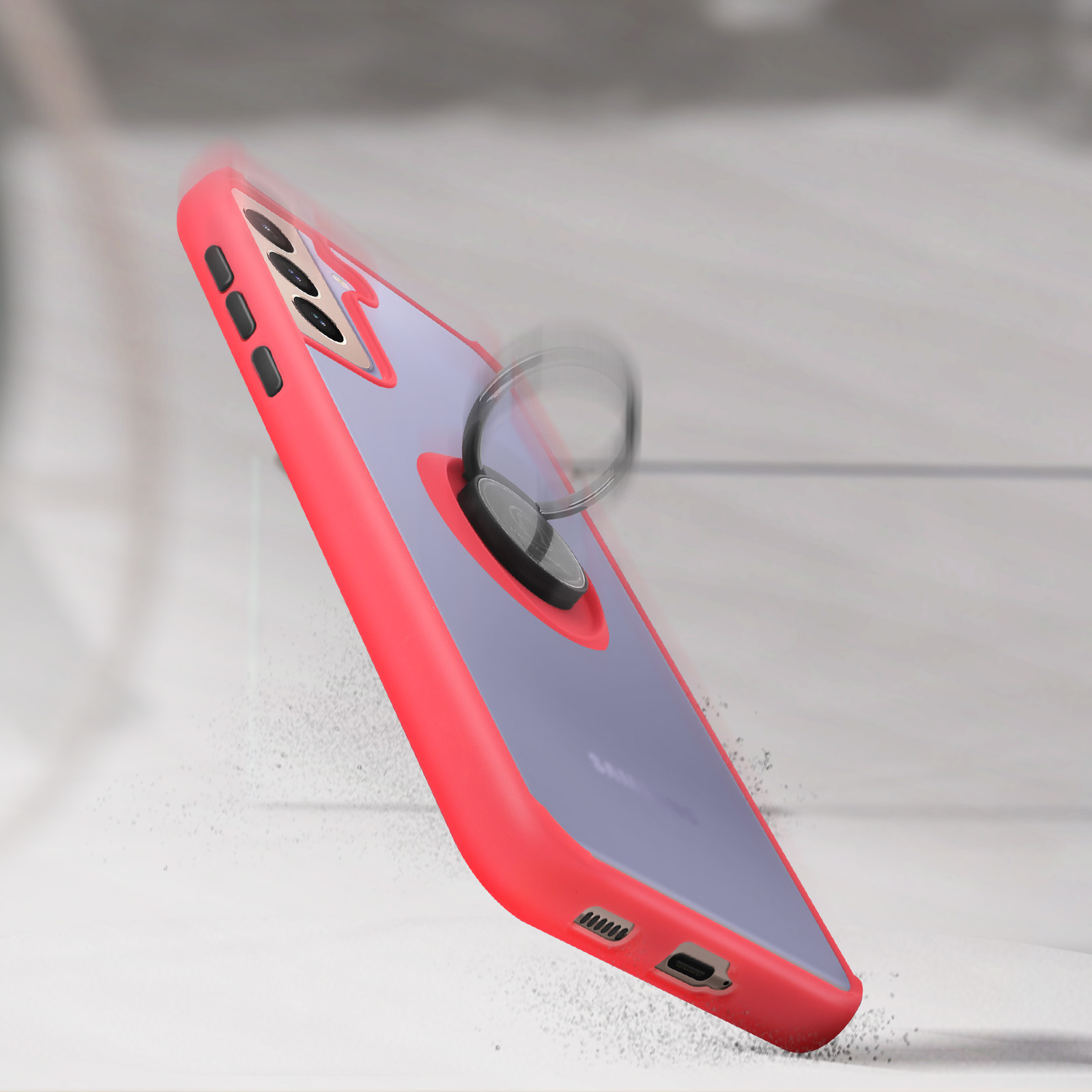 Téléphone tombant, support d'anneau visible. Le téléphone a un étui rouge et est sur une surface grise.