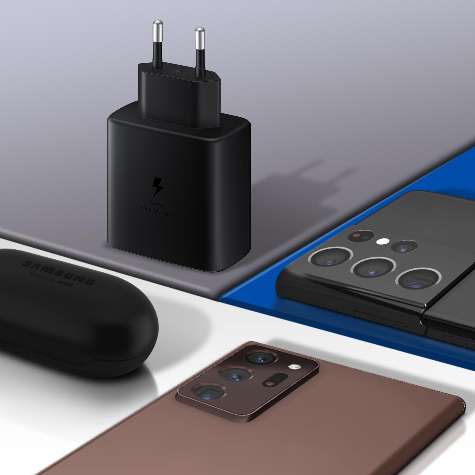 Un chargeur noir et des écouteurs à côté de deux téléphones. Un téléphone a une coque transparente.