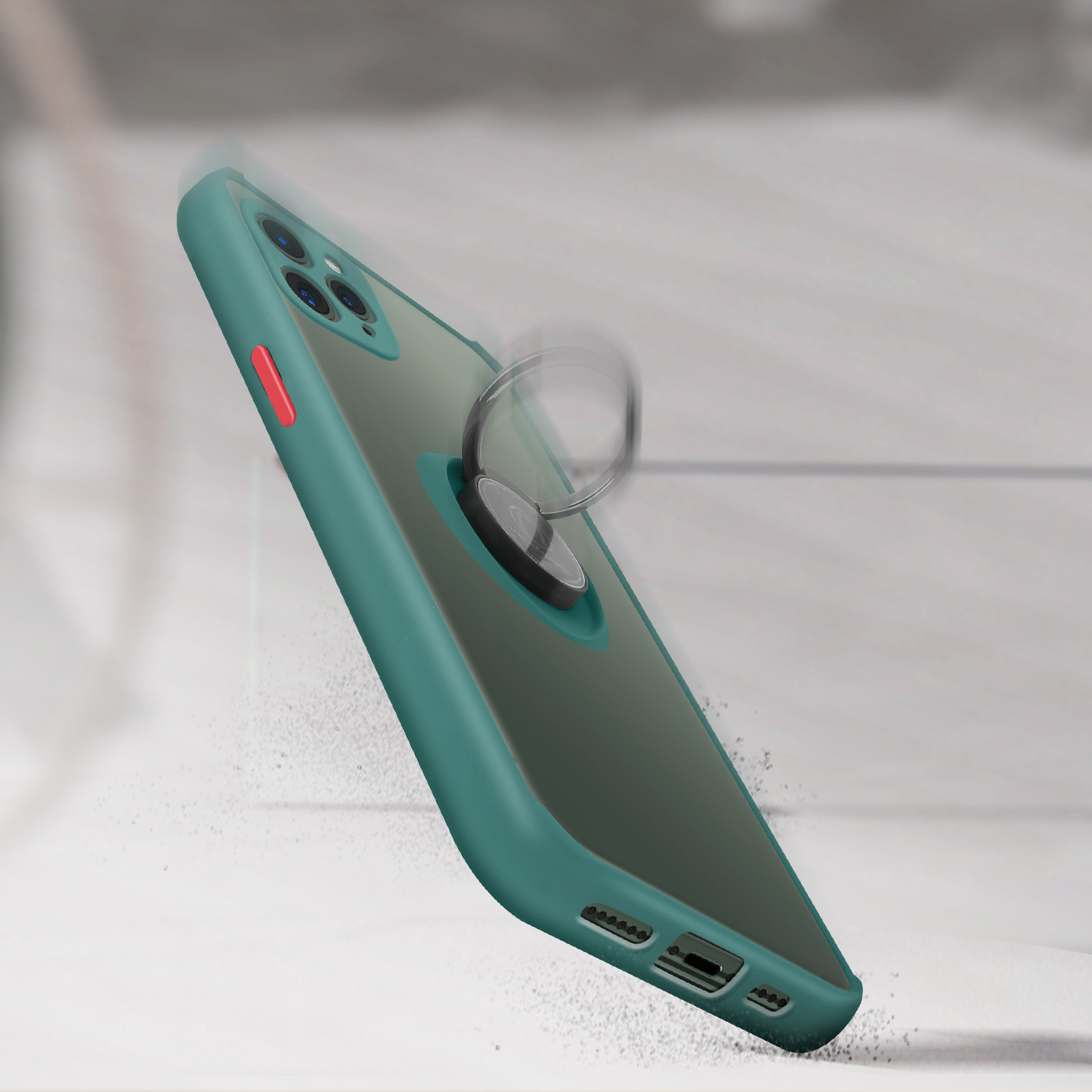Una custodia verde per telefono con supporto ad anello, che cade su una superficie, con sfocatura del movimento.