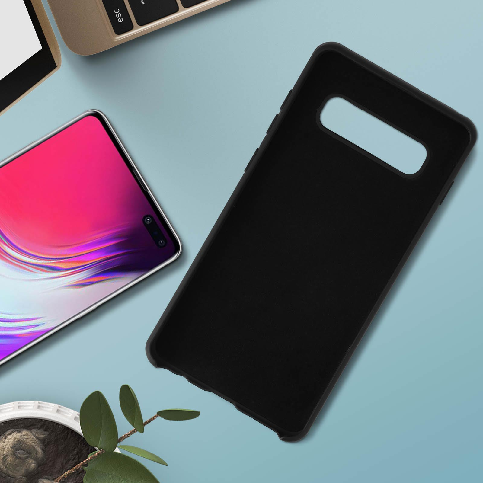 Coque de téléphone noire sur une surface bleue, avec un ordinateur portable et une plante en arrière-plan.