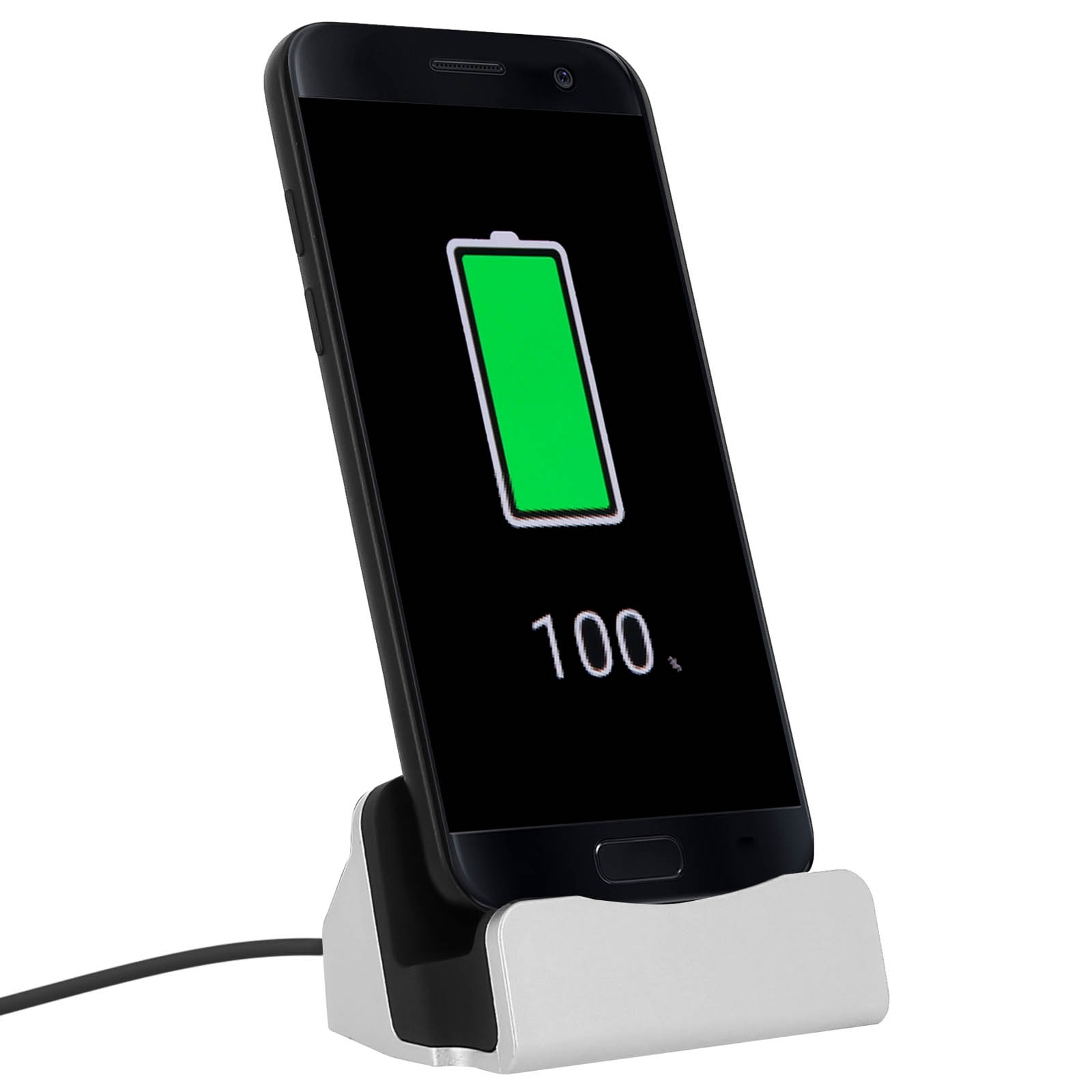 Telefono in carica su una docking station argentata, schermo che mostra batteria verde al 100%.