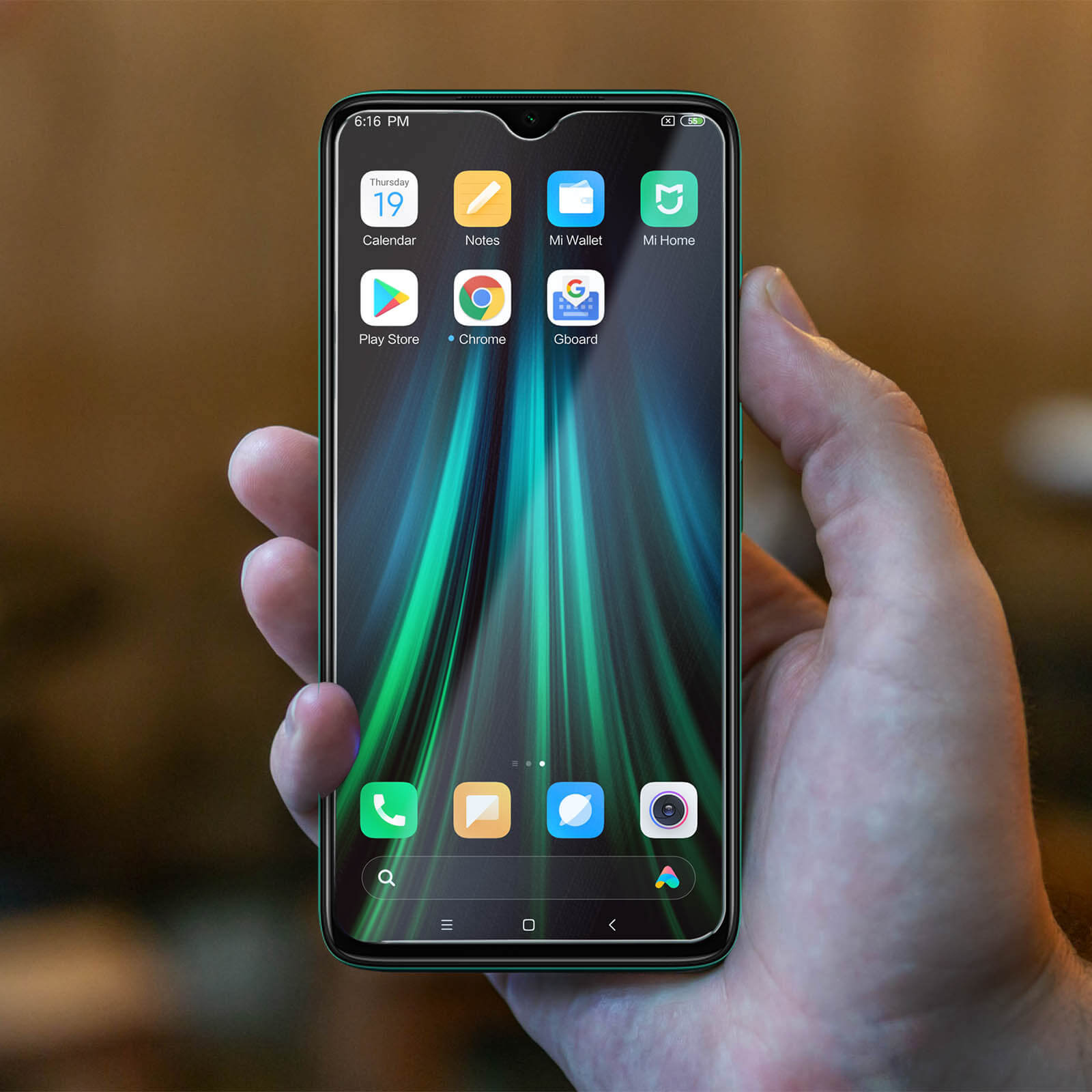 Una mano tiene un telefono con app visibili sullo schermo, l'ora è 18:16.