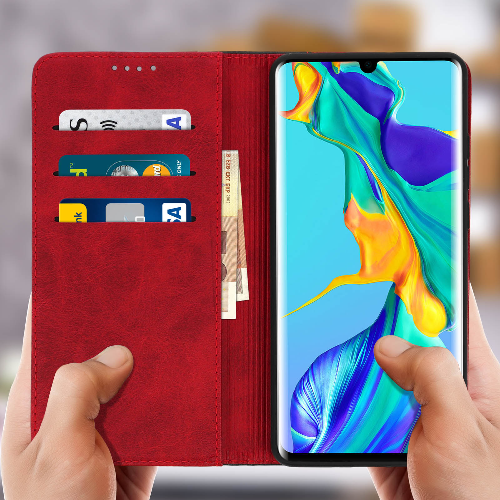 Custodia a portafoglio rossa per telefono aperta, con carte e denaro. Telefono che mostra un'immagine colorata.