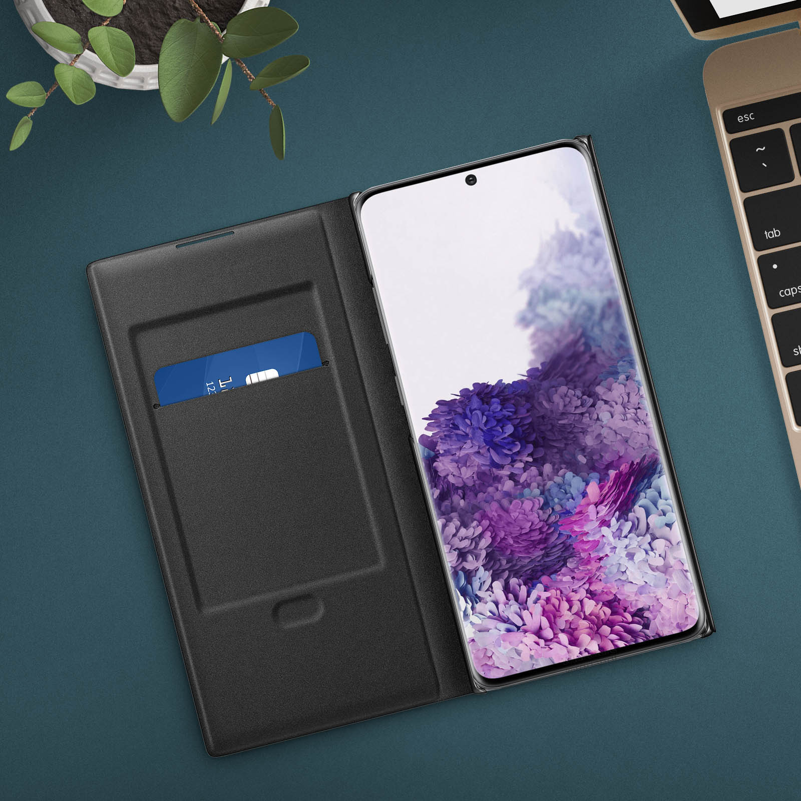 Funda negra de teléfono abierta para revelar una ranura para tarjeta de crédito y pantalla con flores moradas.