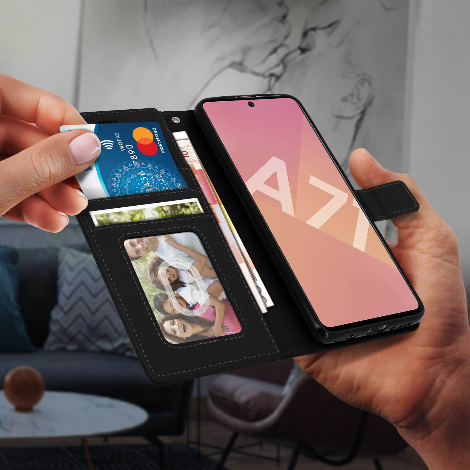 Mano che tiene un portafoglio con carta di credito e un telefono con display rosa.