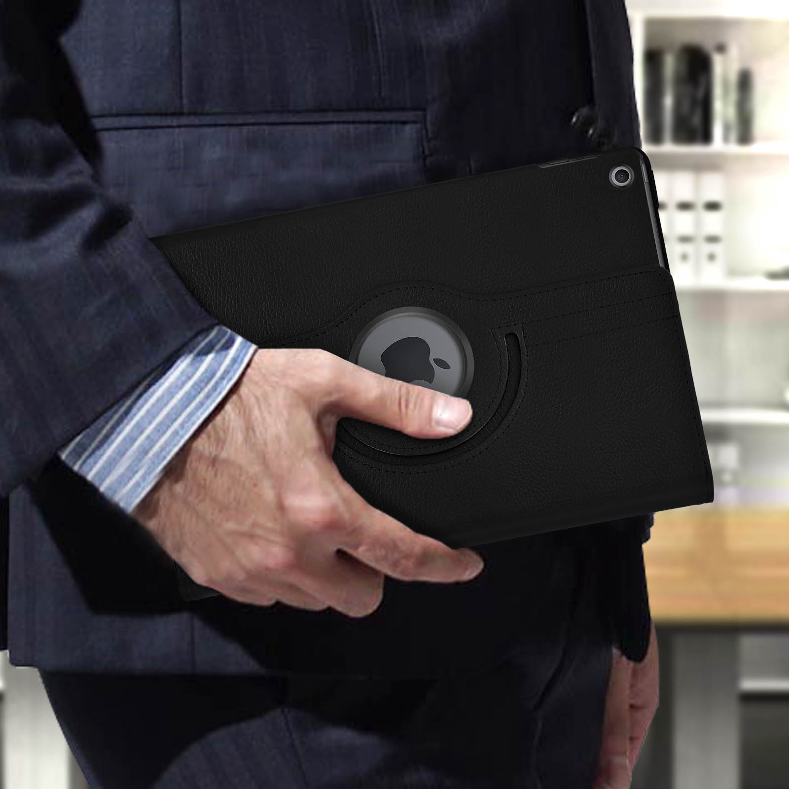 Persona che tiene in mano una custodia nera per iPad, ruotando il logo Apple.