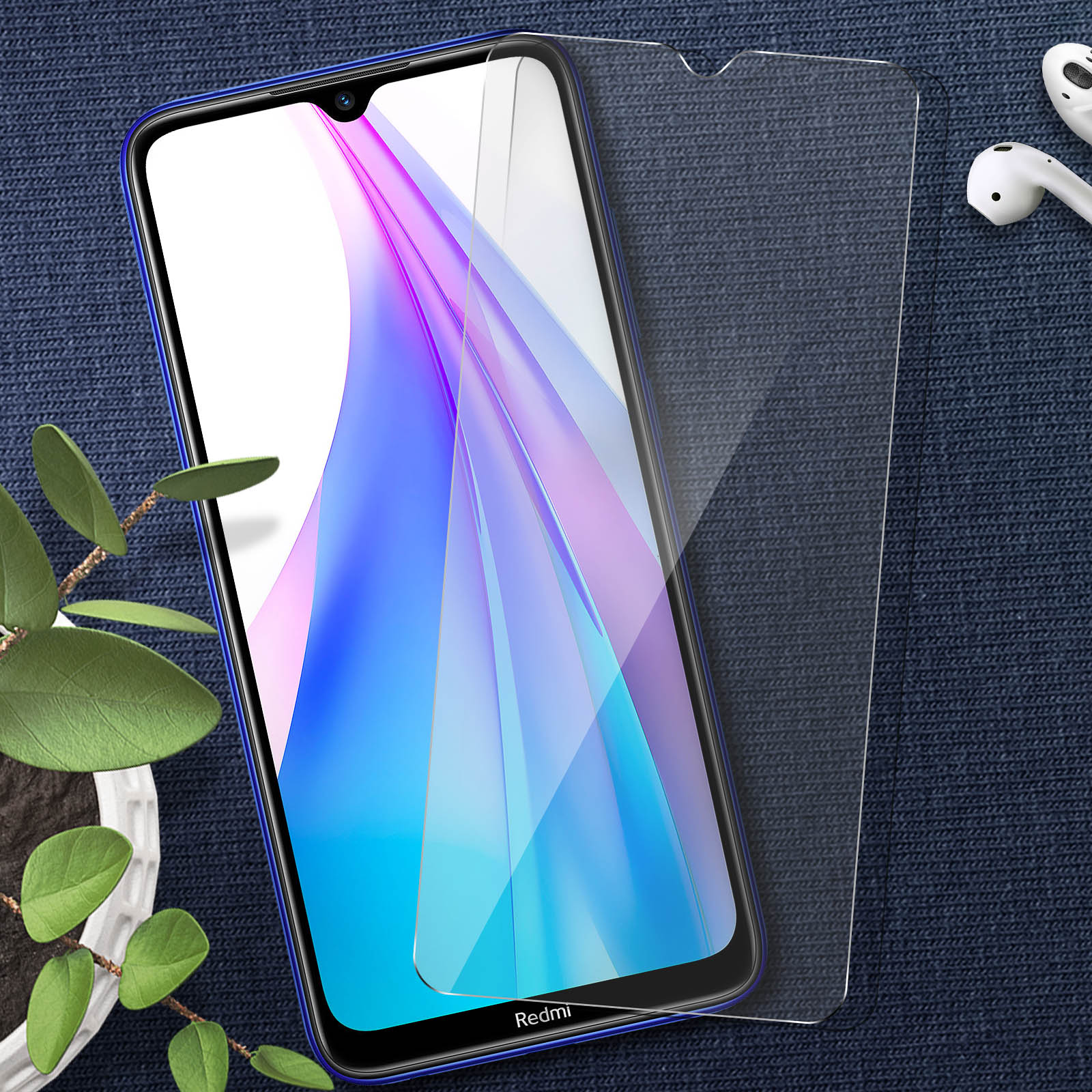 Telefono blu con protezione schermo, su una superficie strutturata. Un auricolare bianco visibile.