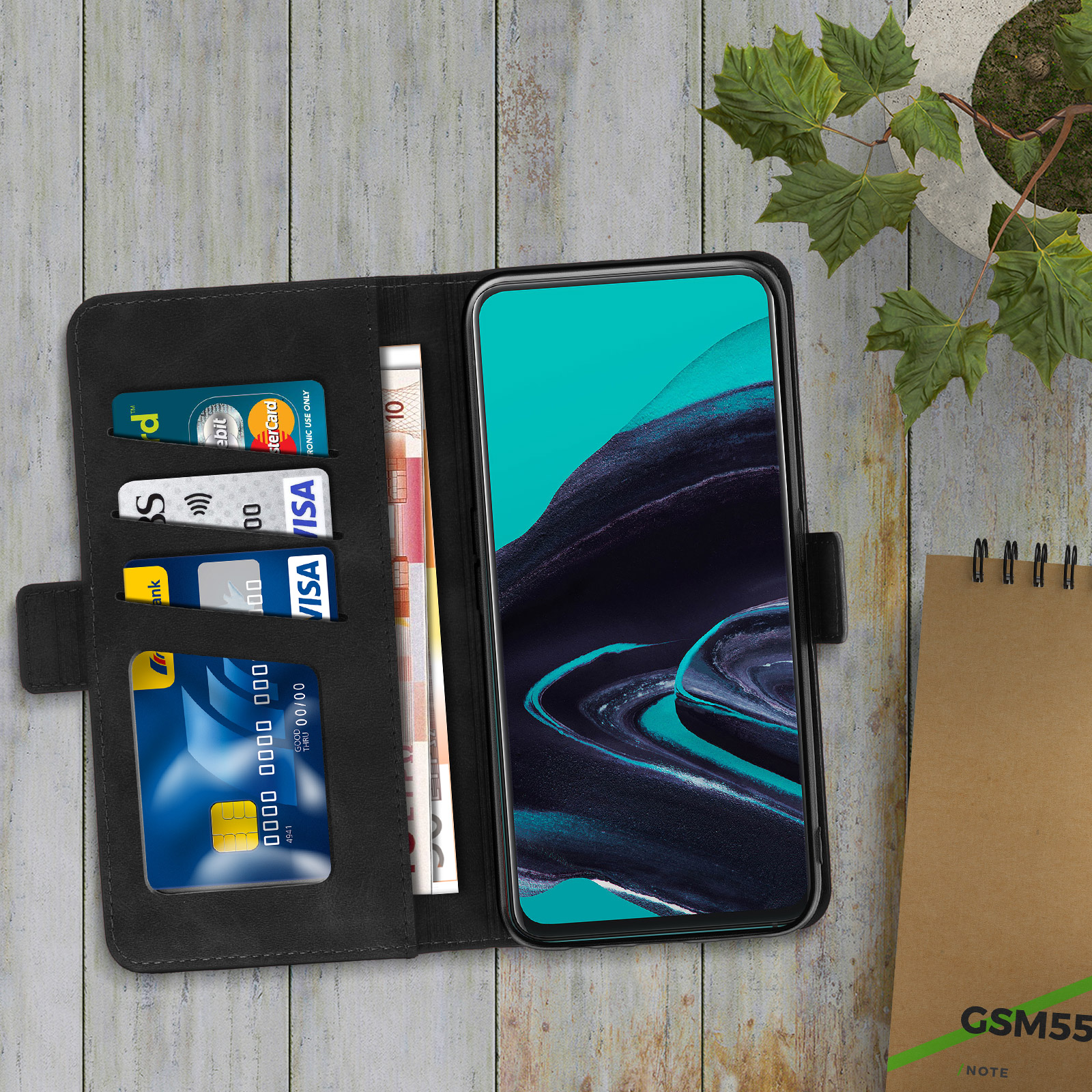 Coque de téléphone noire avec téléphone, cartes de crédit et argent liquide. L'étui est ouvert.