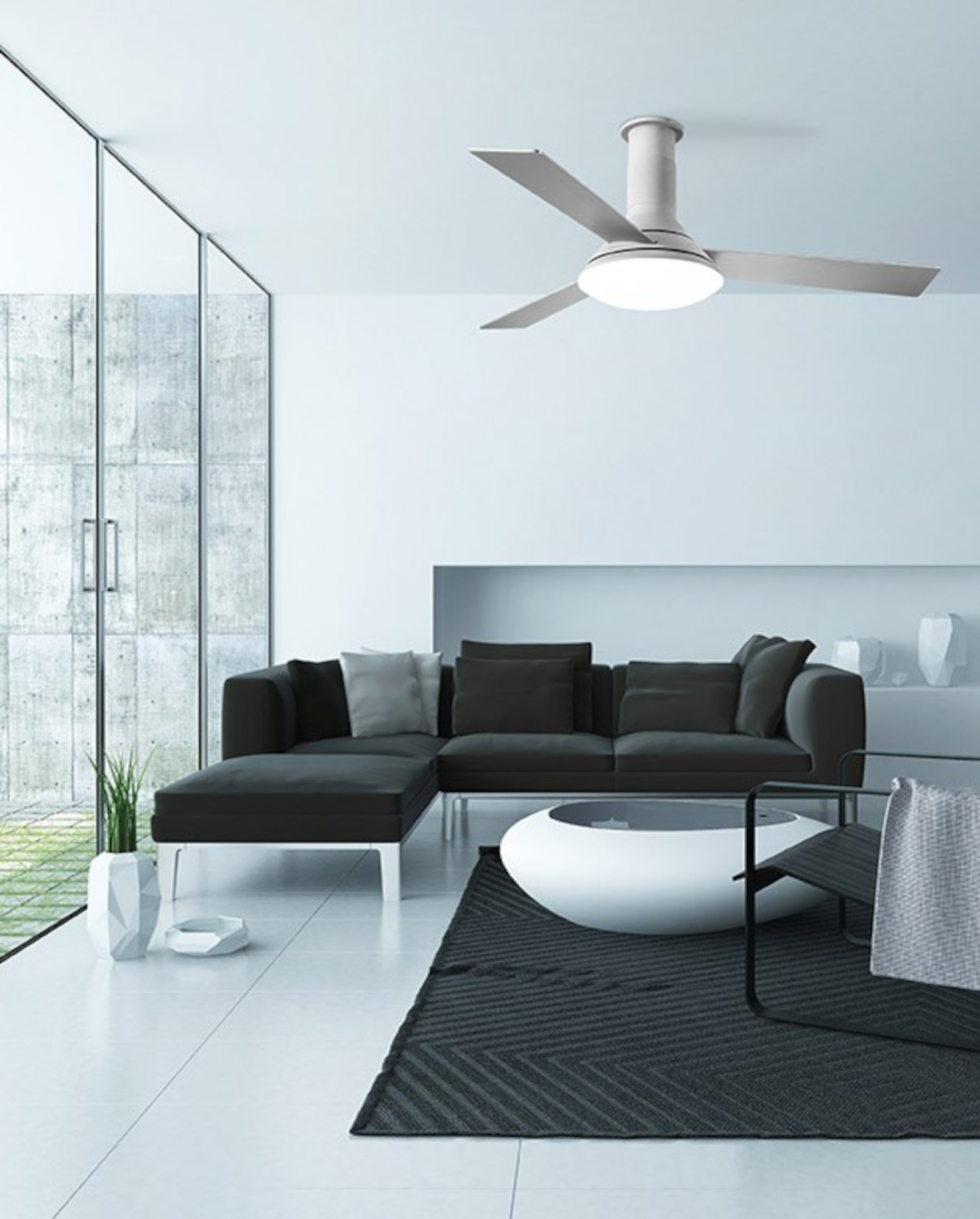 Modernes Wohnzimmer mit schwarzen Möbeln, weißen Wänden und Deckenventilator.
