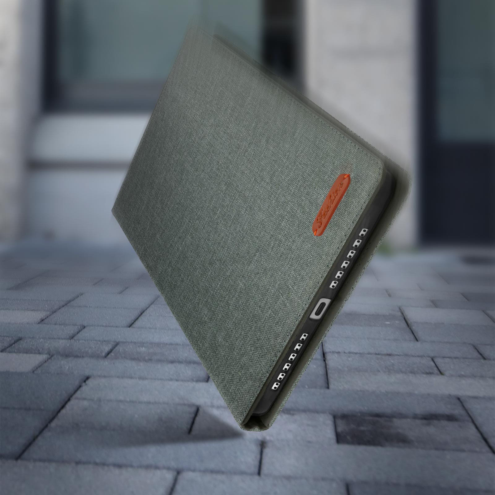 Custodia per tablet in tessuto verde. La custodia è aperta e angolata.