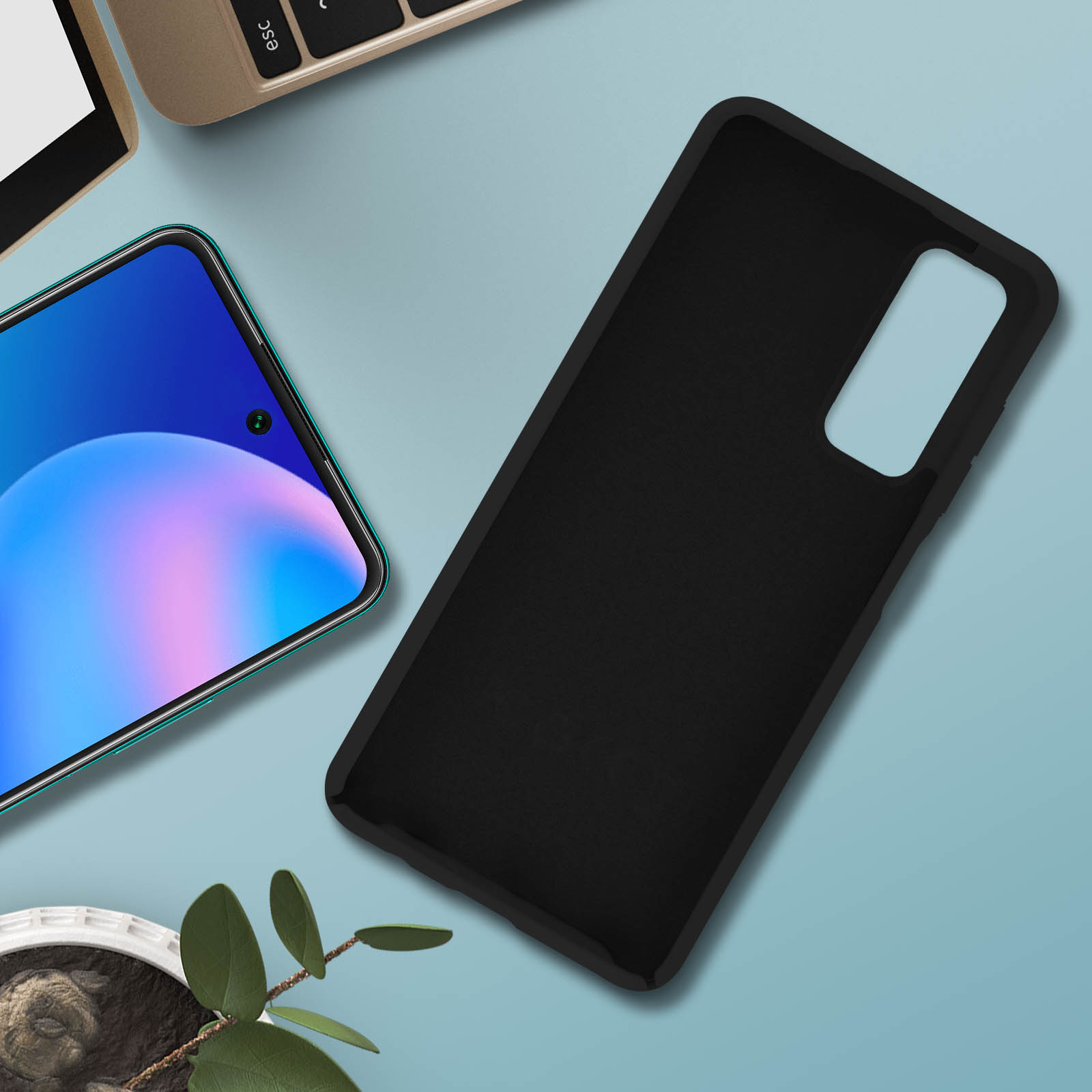 Zwarte telefoonhoes. Een telefoon ernaast, op een blauwe tafel met een groene plant.