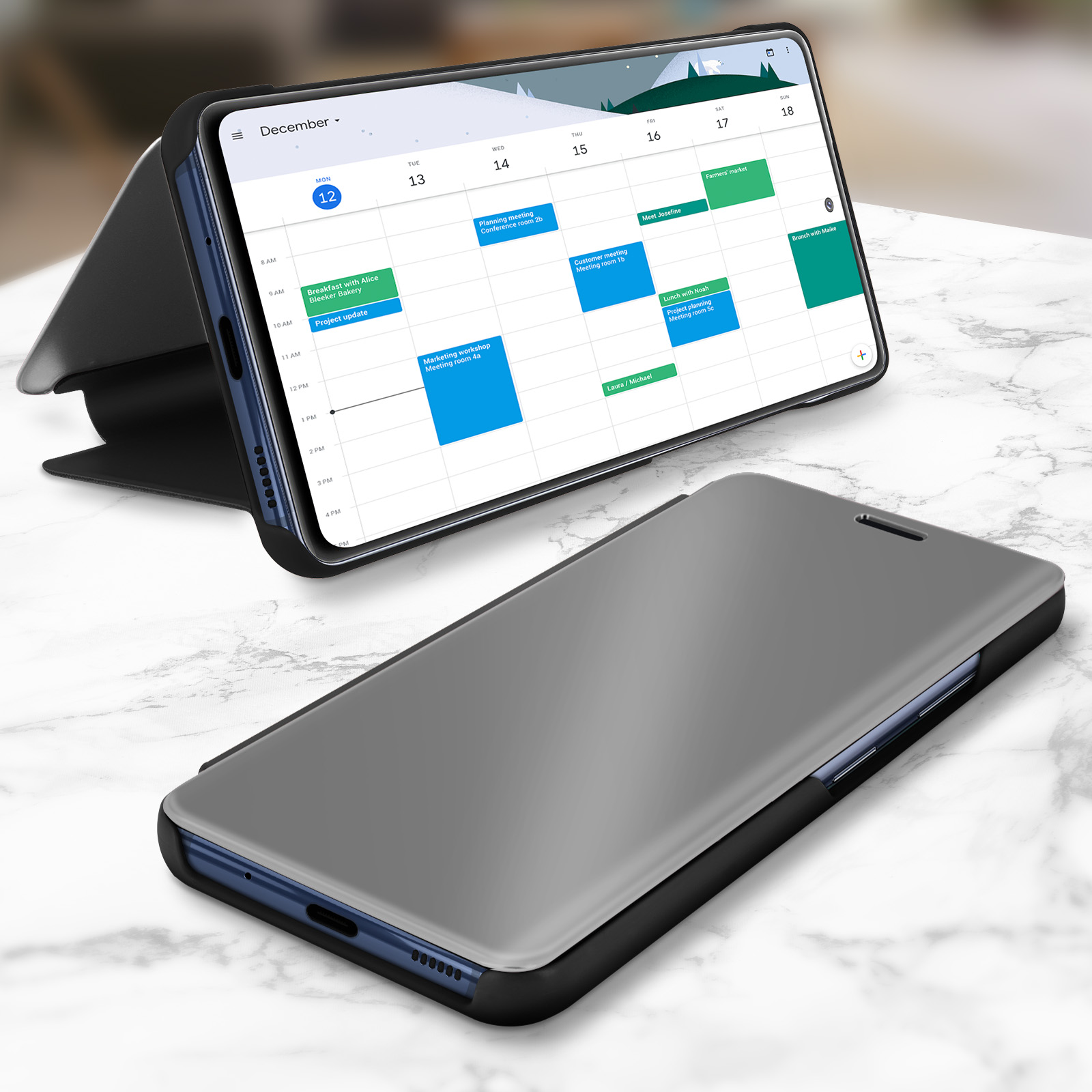 Due telefoni con visualizzazione del calendario su sfondo marmoreo.