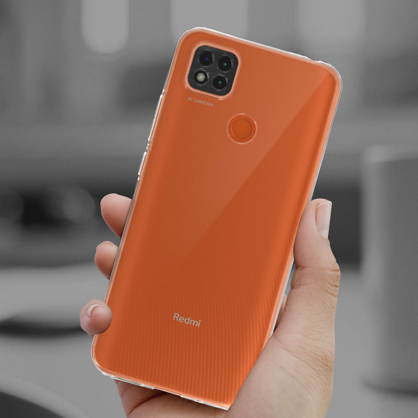 Custodia trasparente arancione per telefono tenuta in mano. Il telefono è visibile.