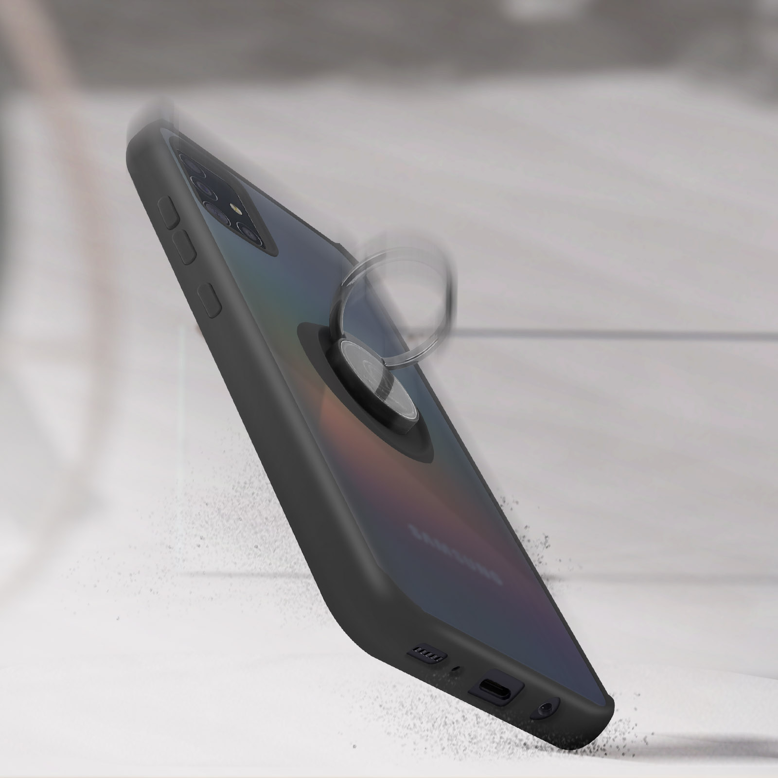 Coque de téléphone avec anneau de maintien, en angle sur une surface, poussière visible.
