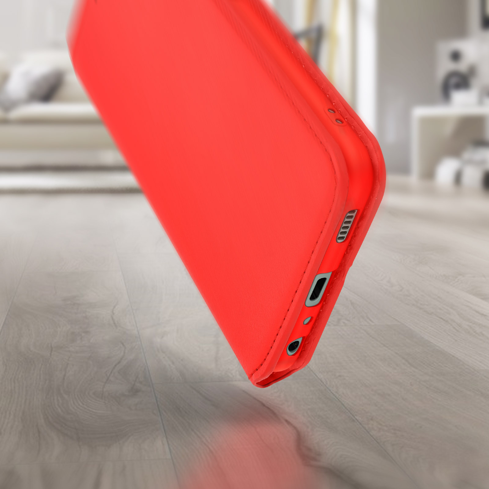 Funda roja para teléfono, vista en ángulo. Muestra el lado con puertos y botones.