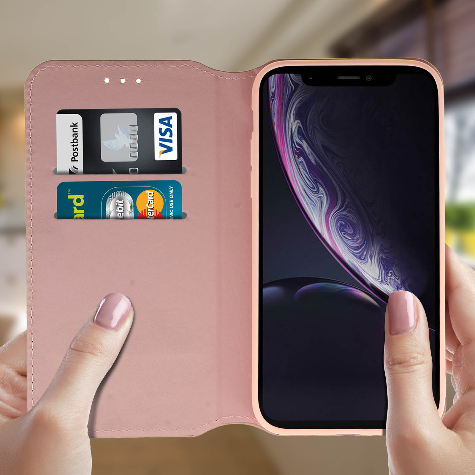 Custodia rosa aperta. All'interno, carte e telefono. Mani che tengono la custodia.