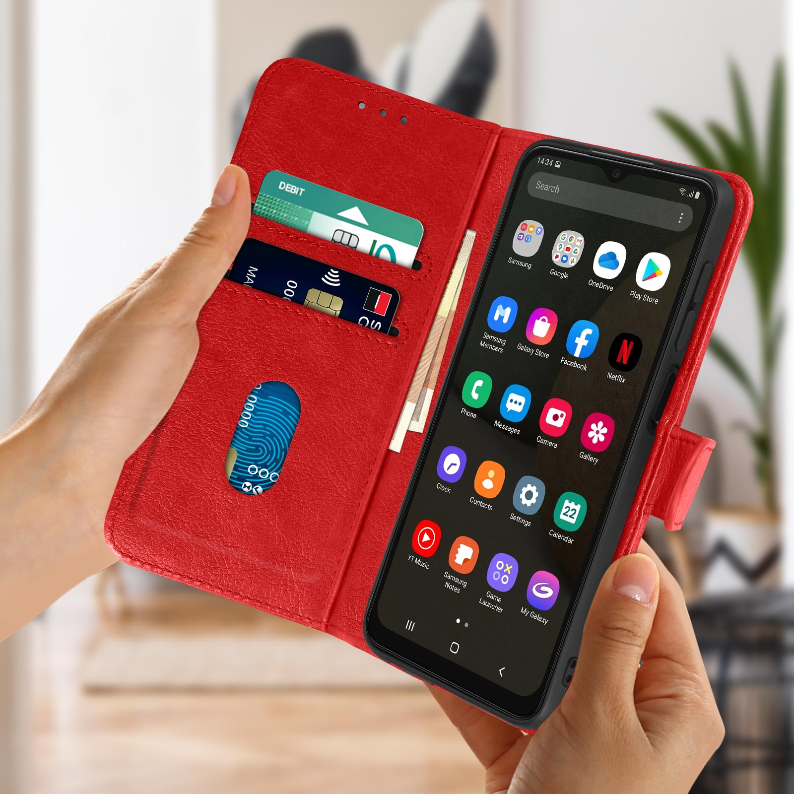 Un portefeuille de téléphone rouge ouvert, montrant un écran de téléphone, des cartes de crédit et de débit.