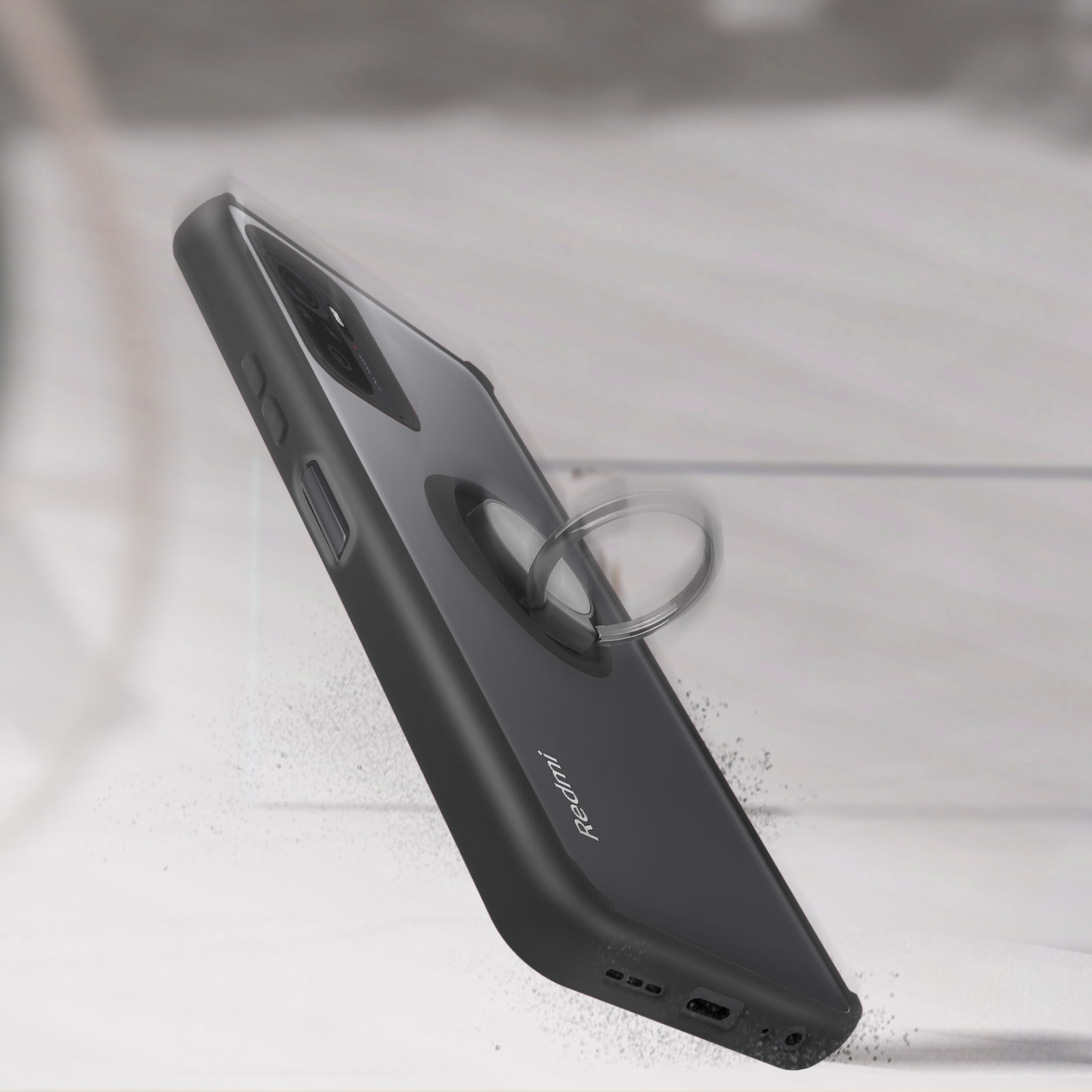 Custodia nera per telefono con anello, inclinata, con particelle di polvere che cadono.