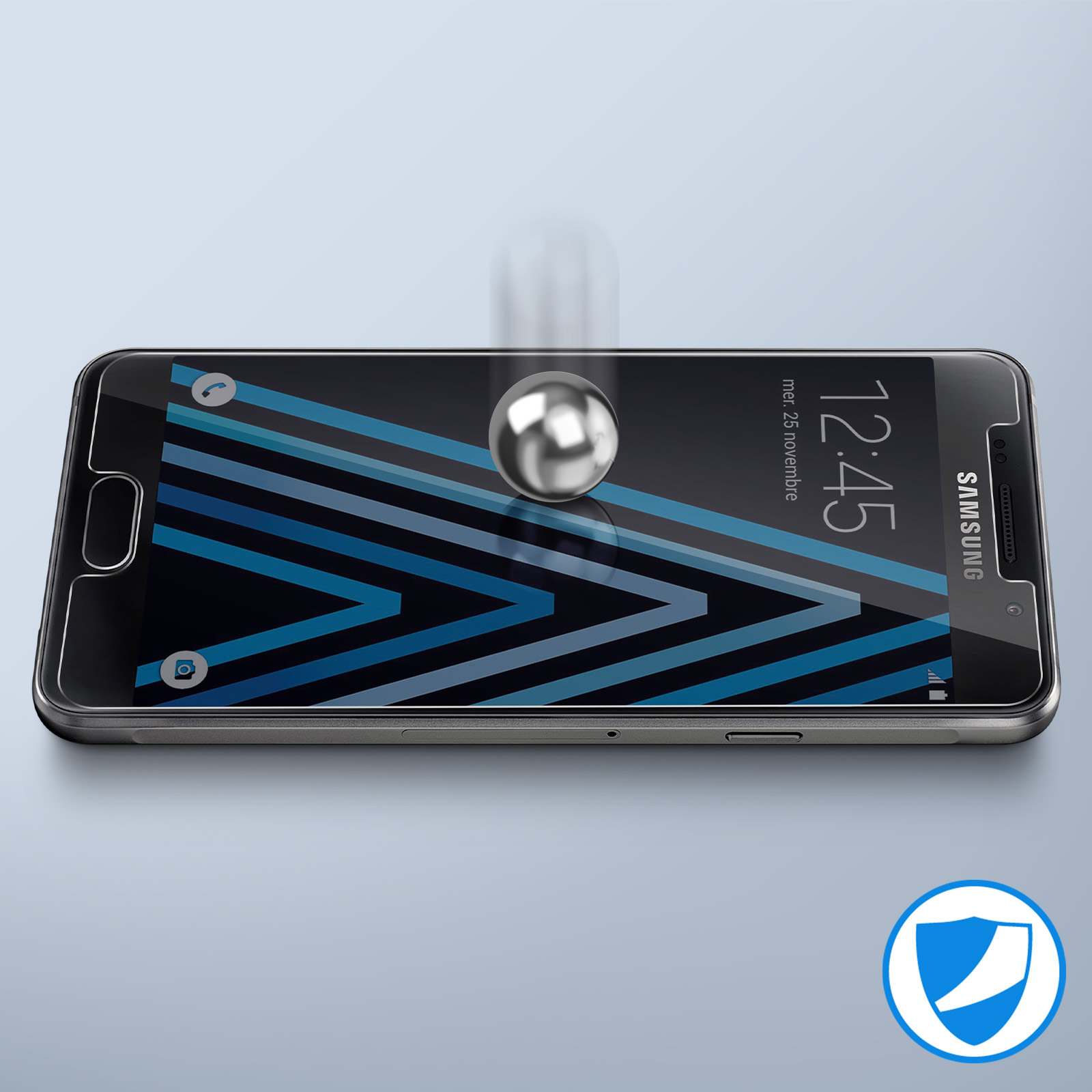 Un teléfono con protector de pantalla y una bola de metal cayendo hacia la pantalla.