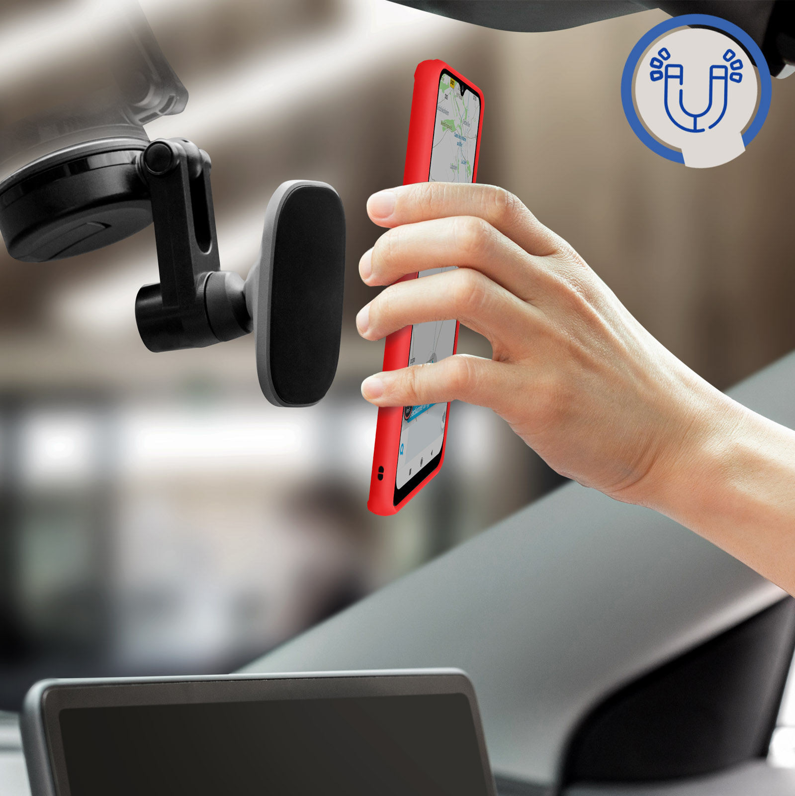 Una mano che attacca un telefono rosso a un supporto magnetico per auto. Sfondo è un'auto.