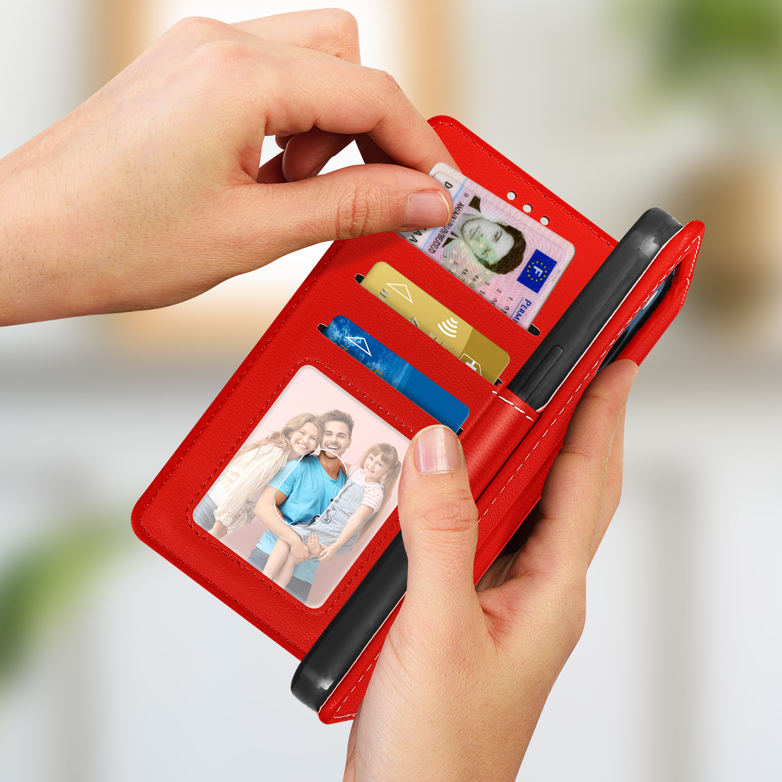 Une personne tient un étui de téléphone-portefeuille rouge avec des photos, des cartes et un permis de conduire.