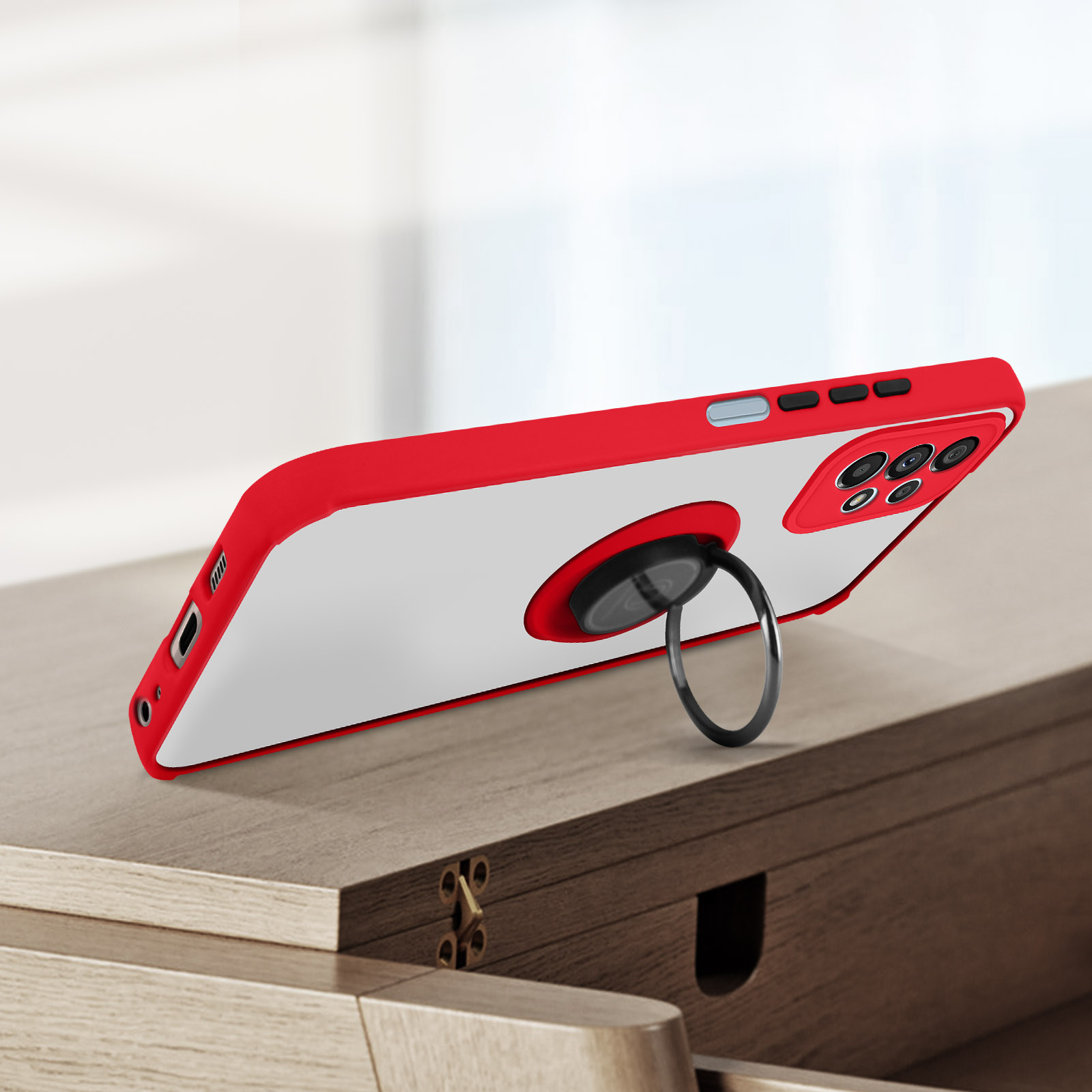Un étui de téléphone rouge avec un support d'anneau, sur une surface en bois.