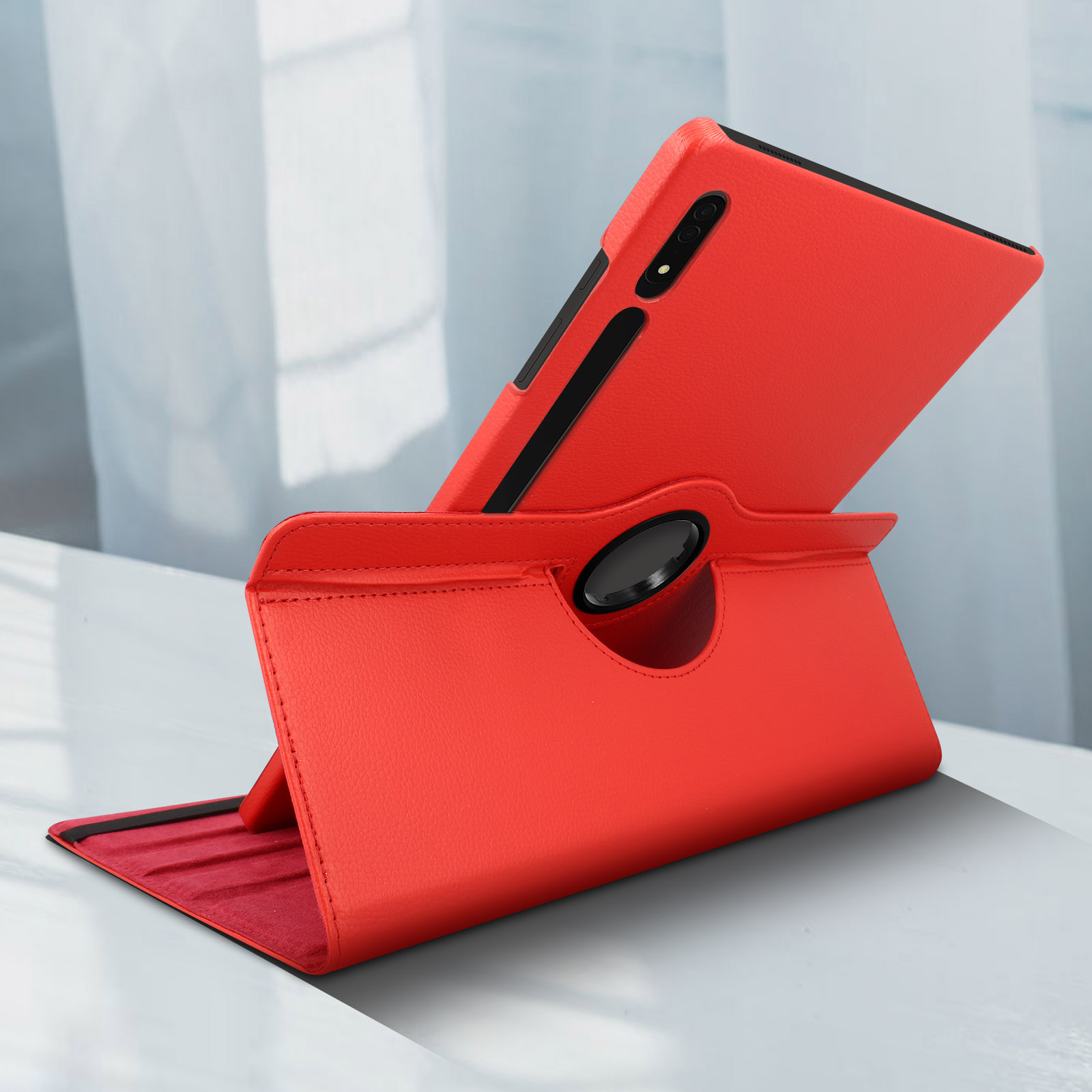 Un telefono rosso in una custodia con supporto. La custodia è su una superficie bianca riflettente.