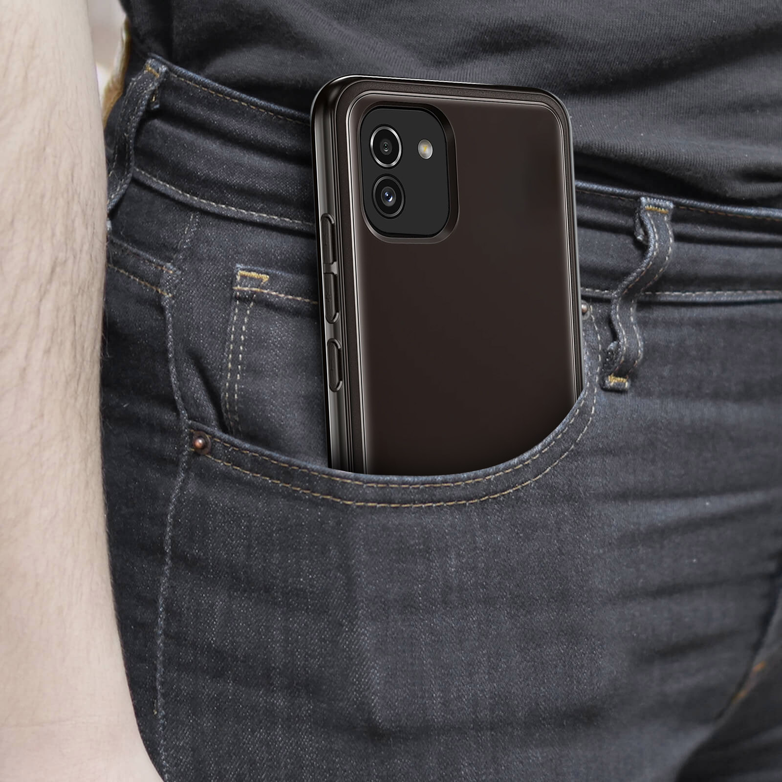 Phone in a jeans pocket. Black phone with a case. Denim texture is visible.