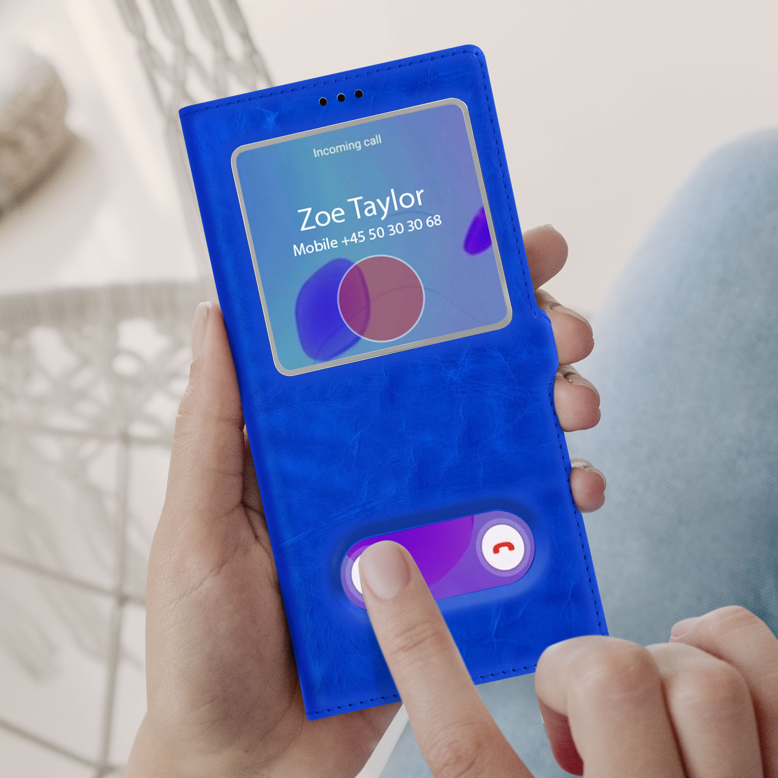 Une coque de téléphone bleue avec un écran affichant un appel entrant de Zoe Taylor. L'écran est allumé.