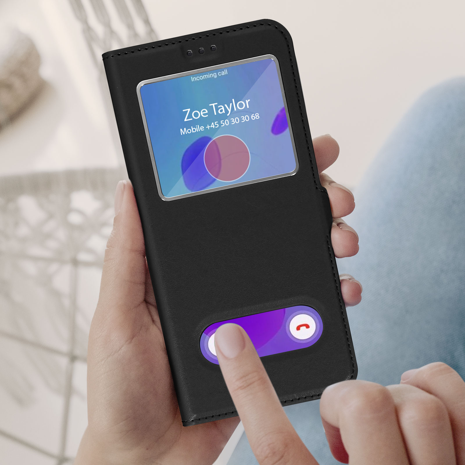Hand die een zwarte telefoonhoes vasthoudt met een inkomende oproep. Vinger drukt op antwoordknop.