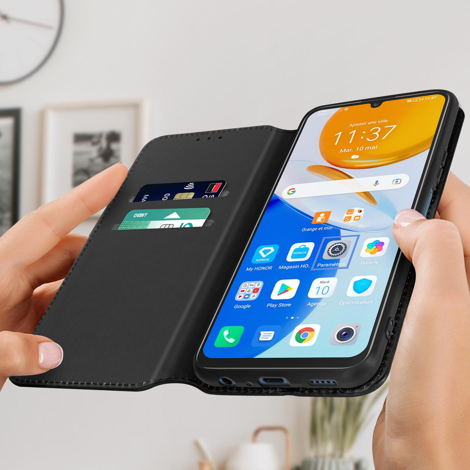 Una donna tiene in mano un telefono con una custodia nera, mostrando lo schermo.