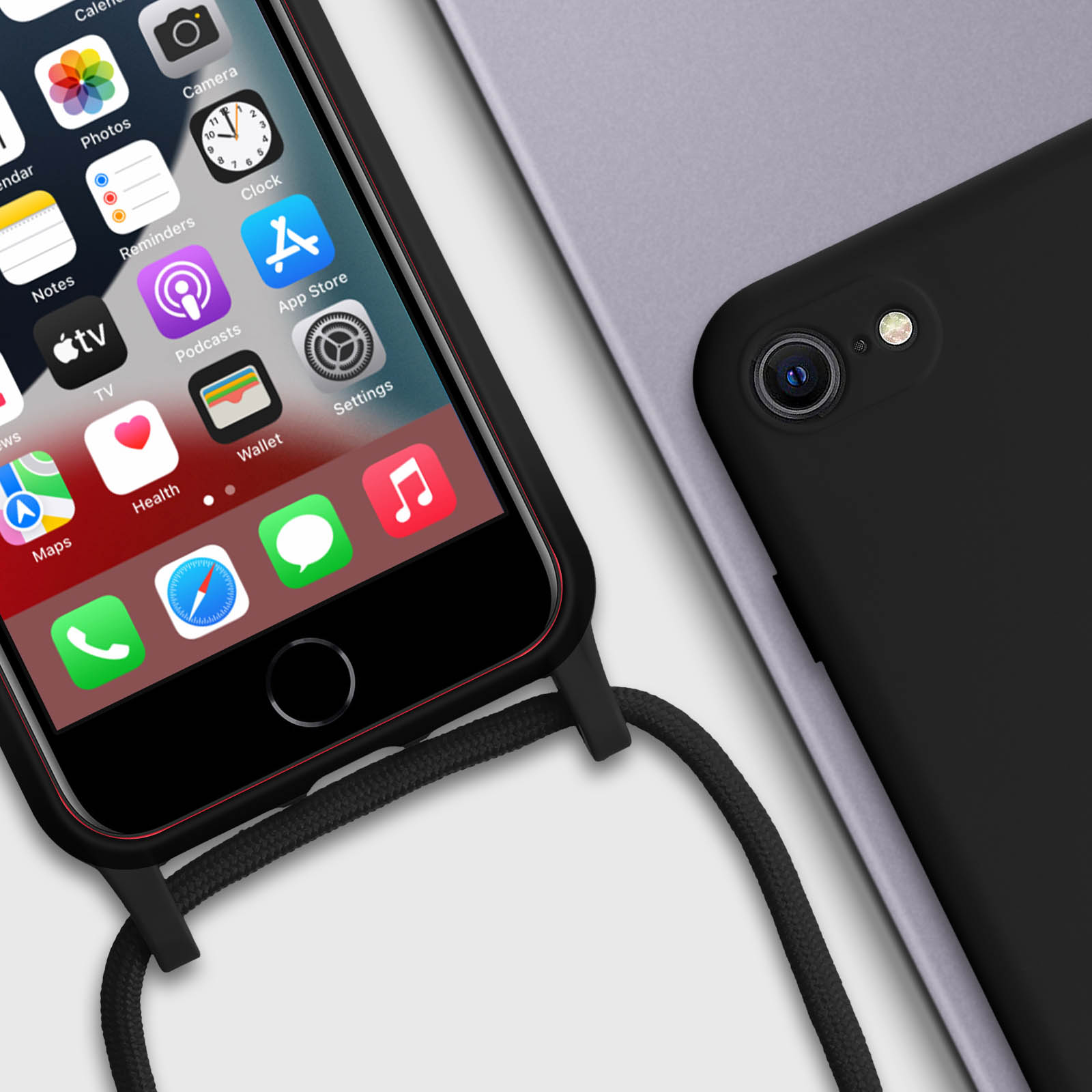 Un téléphone noir avec un cordon. L'écran affiche des icônes d'applications. Un autre téléphone noir à côté.