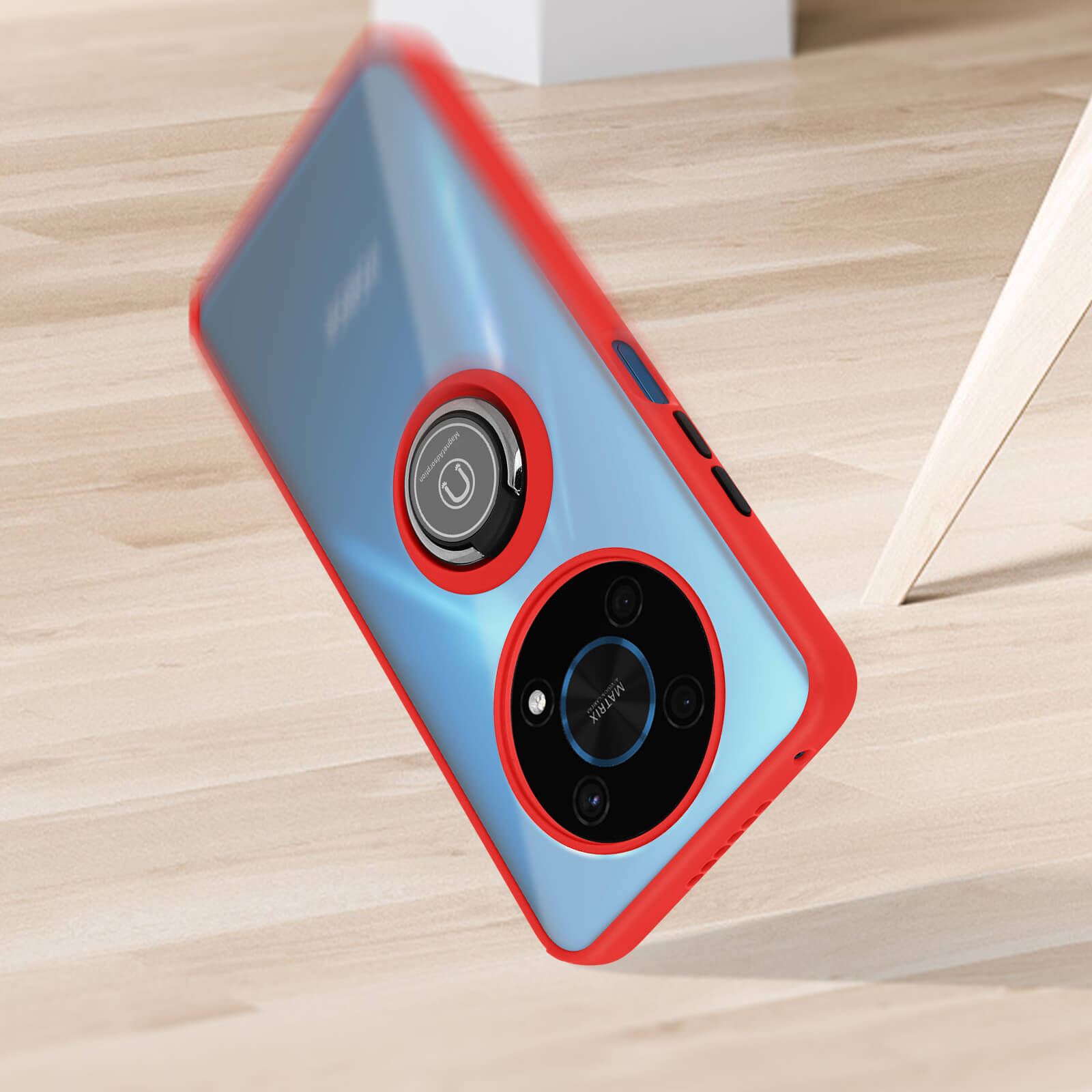Coque de téléphone rouge avec anneau de maintien, inclinée sur une surface en bois. L'arrière-plan est flou.
