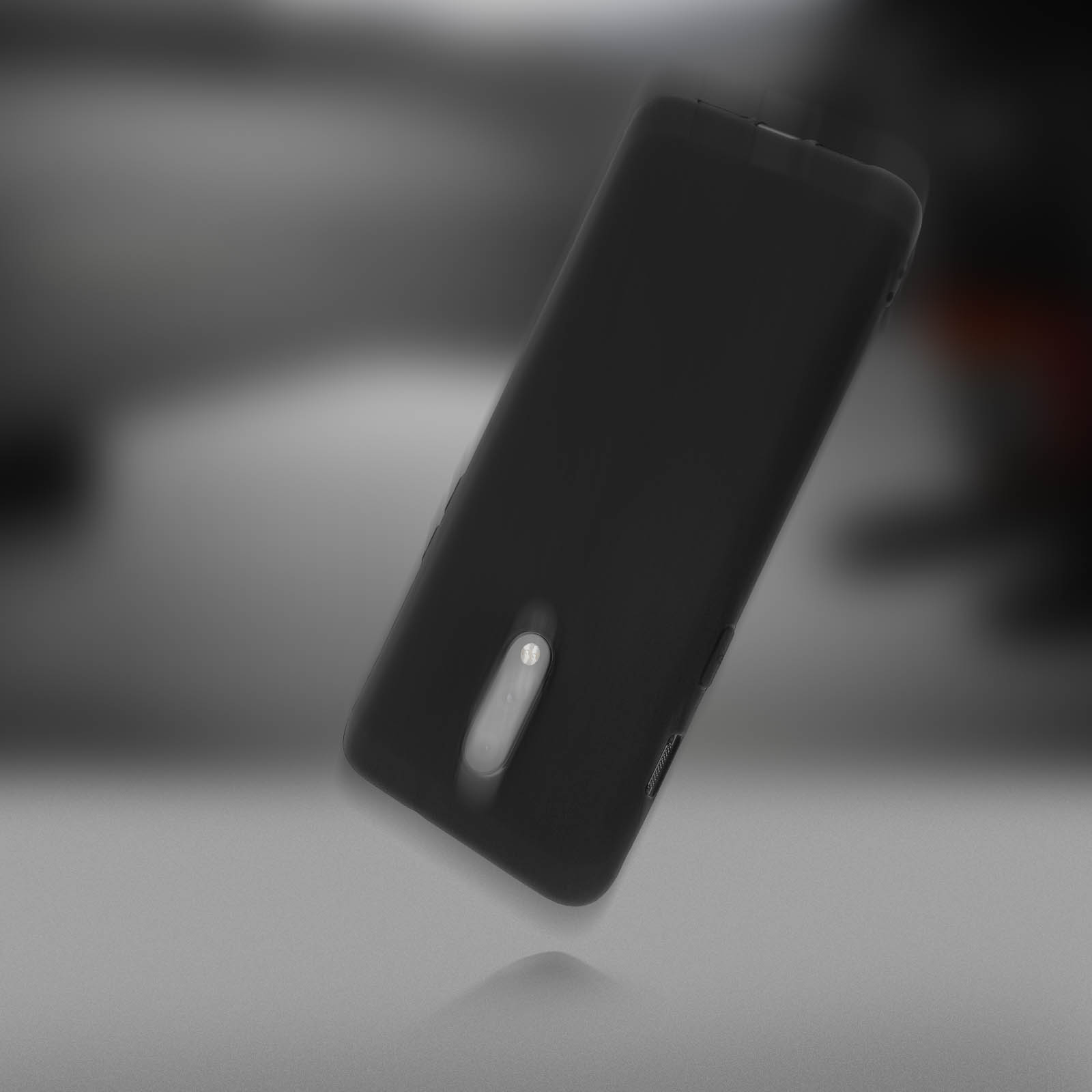 Telefono nero. Il telefono è in levitazione su uno sfondo sfocato. Lo sfondo è una sfumatura di luce.