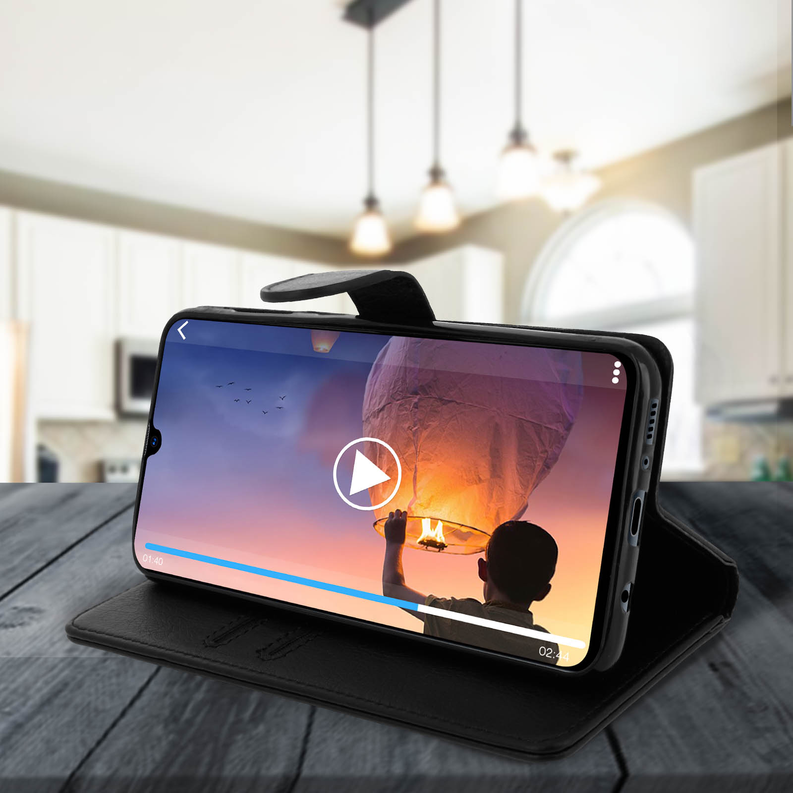 Téléphone dans un étui diffusant une vidéo d'un festival de lanternes. Fond de table en bois noir.